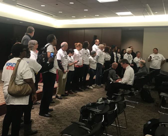 Protesters took over an EPA hearing room in Chicago on October 1, 2018 in protest of the agency's proposed Affordable Clean Energy rule. CREDIT: TARA RAGHUVEER/PEOPLE'S ACTION