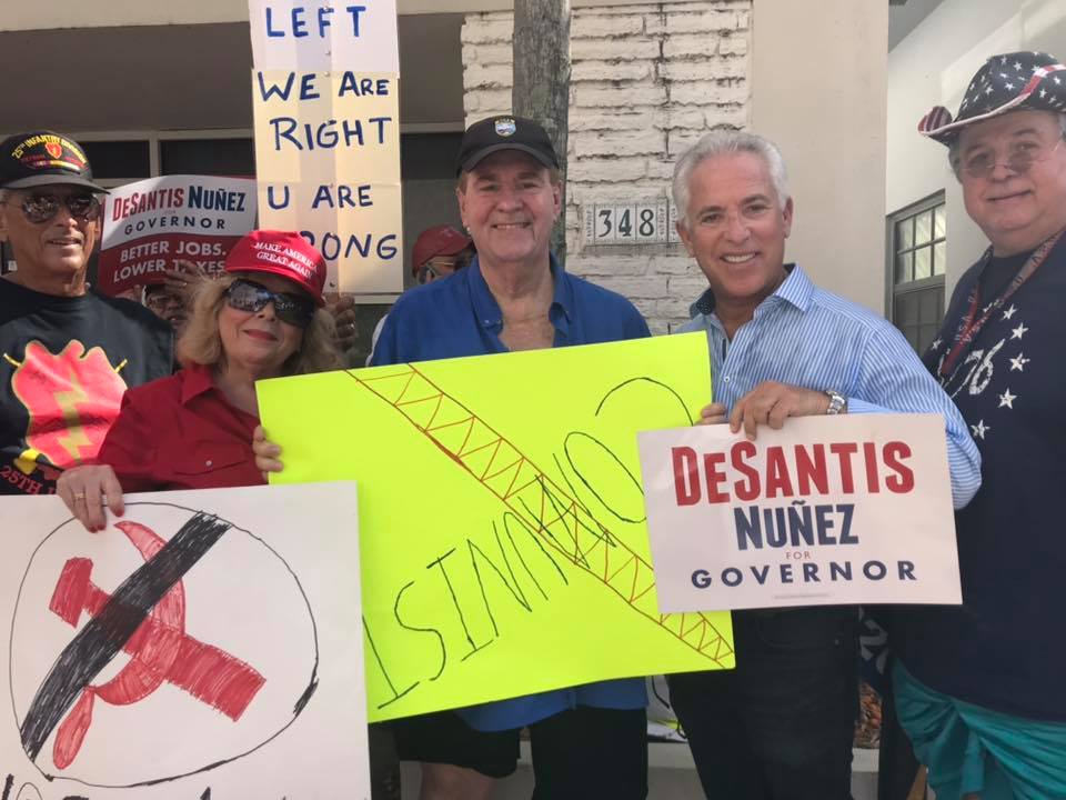 Corey Breier holds a Ron DeSantis sign at Wednesday's demonstration. (Frank de Varona/Facebook)