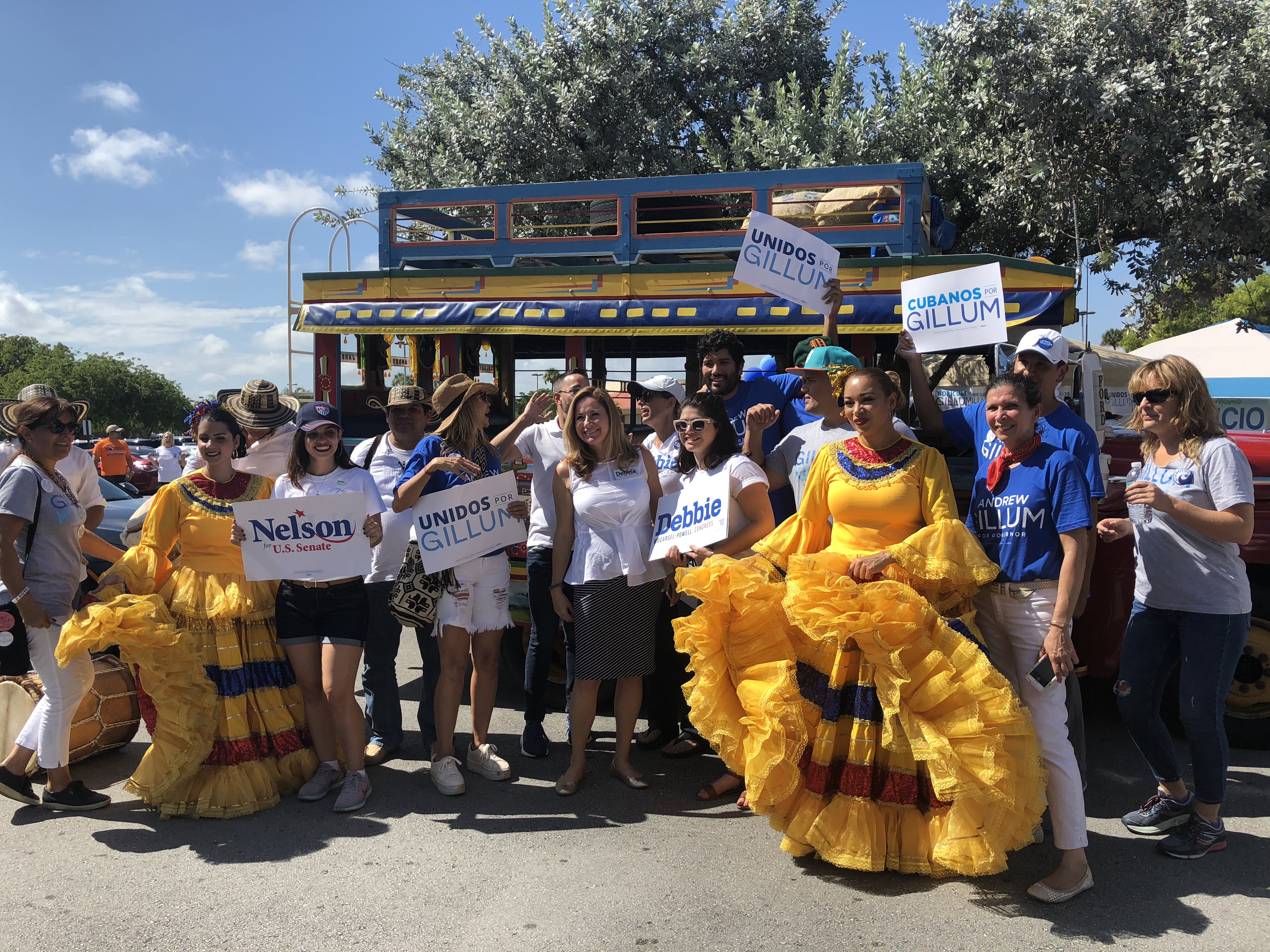 Democratic Congressional candidate Debbie Mucarsel Powell with supporters in front of the Chiva bus in Miami, Florida (Credit: Rebekah Entralgo)