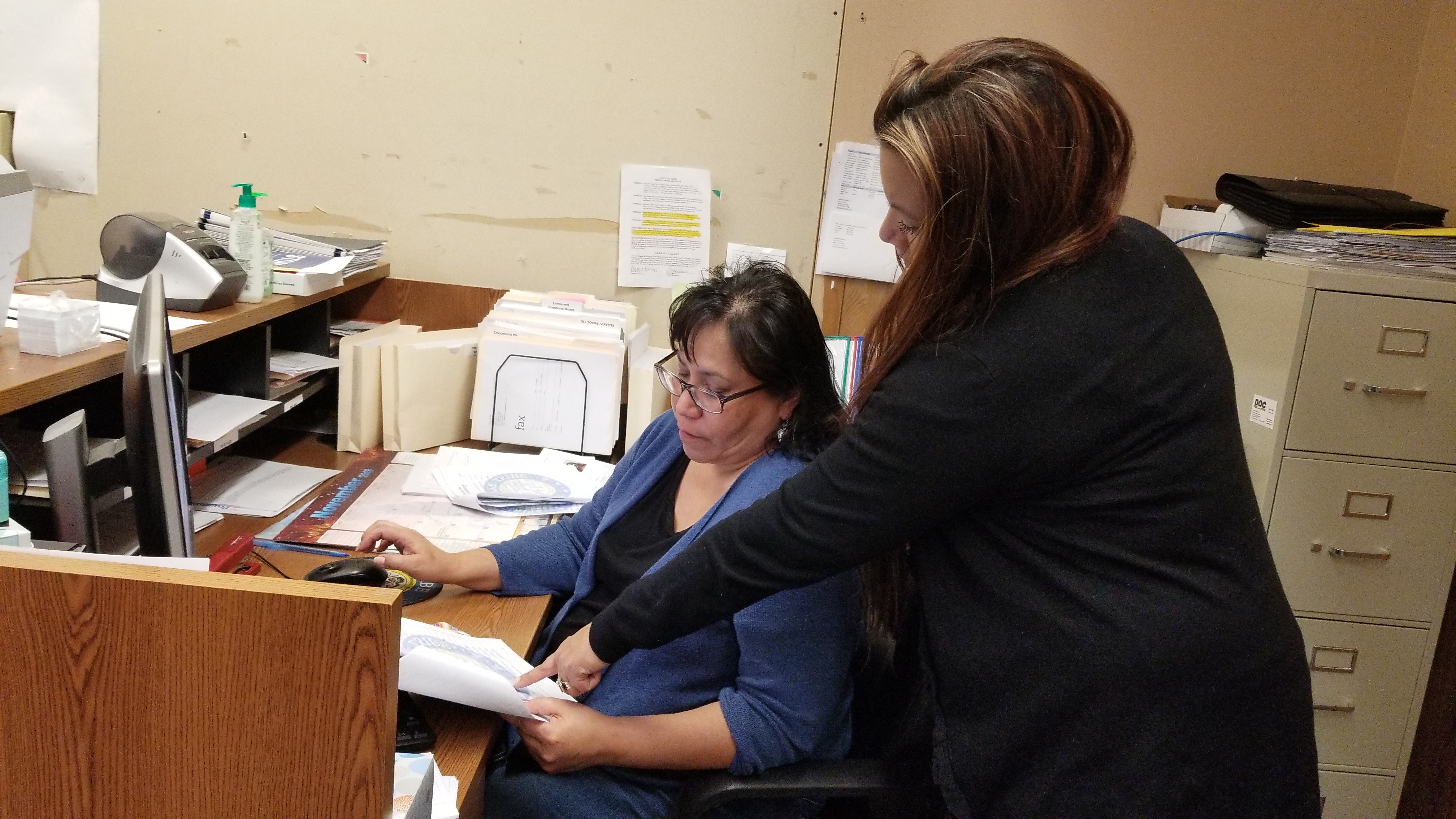 Robin Smith, Spirit Lake Tribe's enrollment director, works to determine why tribal IDs do not match the addresses in the state voter database with the tribe's Secretary-Treasurer Lonna Street.