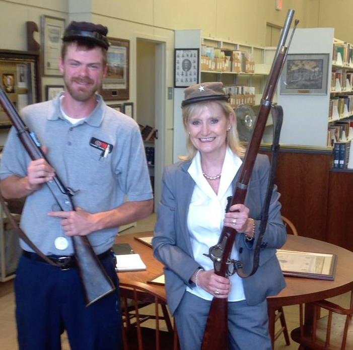 Cindy Hyde-Smith wears a Confederate soldier's hat while posing with the member of a hate group in a picture posted to her Facebook account on August 8, 2014. (Cindy Hyde-Smith/Facebook)