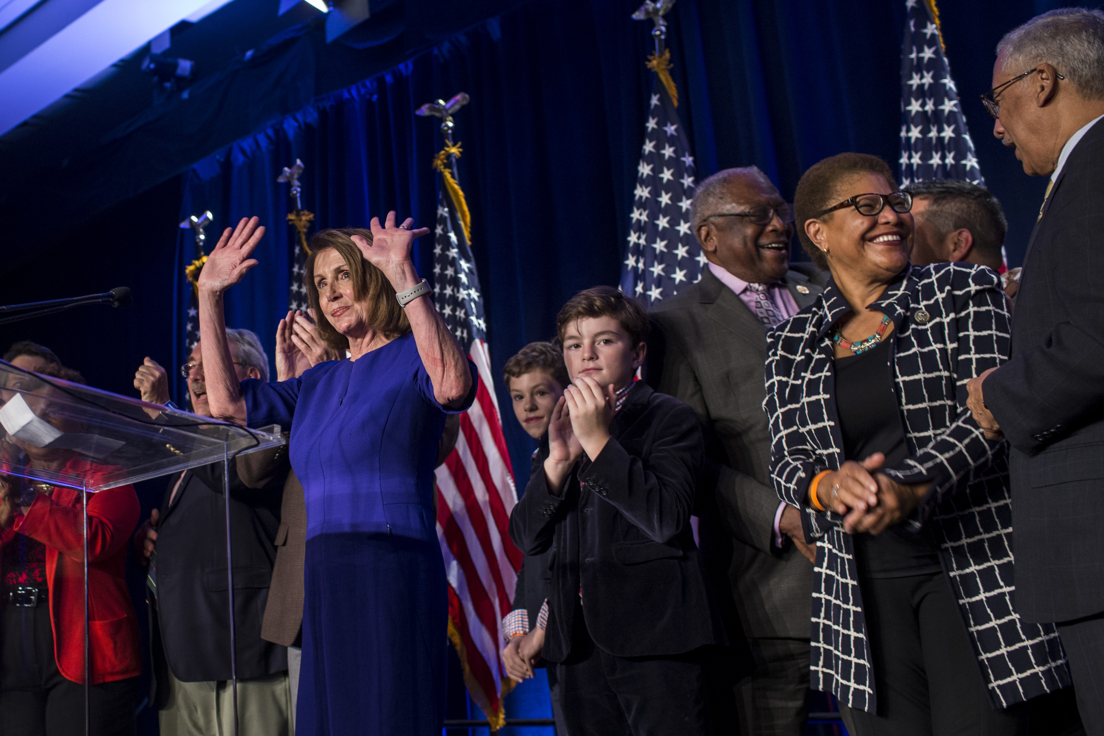 WASHINGTON, DC - NOVEMBER 06: House Minority Leader Nancy Pelosi (D-CA), joined by House Democrats, leaves the podium after delivering remarks during a DCCC election watch party at the Hyatt Regency on November 6, 2018 in Washington, DC. (Photo by Zach Gibson/Getty Images)