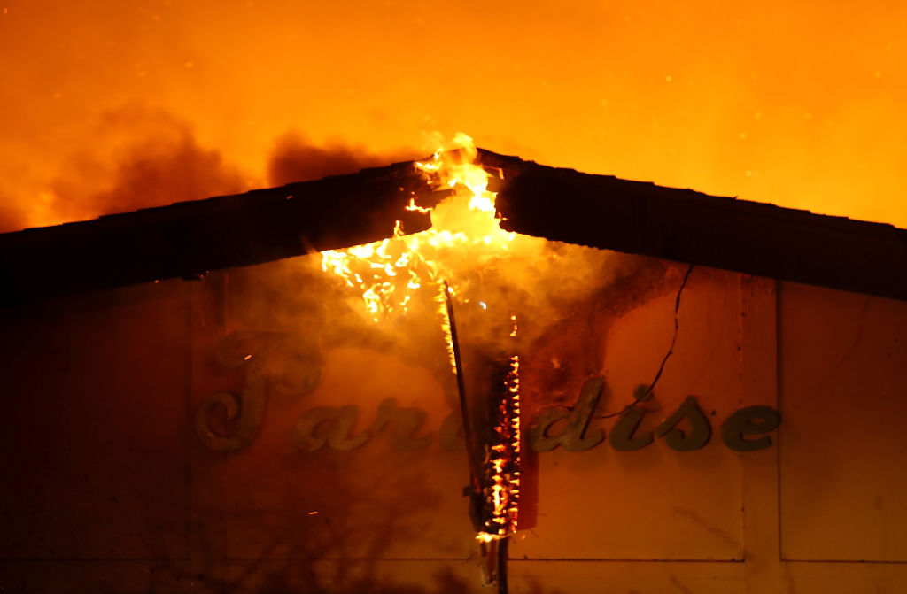 A sign is posted on the Paradise Skilled Nursing center as it is consumed by flames from the Camp Fire on November 8, 2018 in Paradise, California. (Credit: Justin Sullivan/Getty Images)