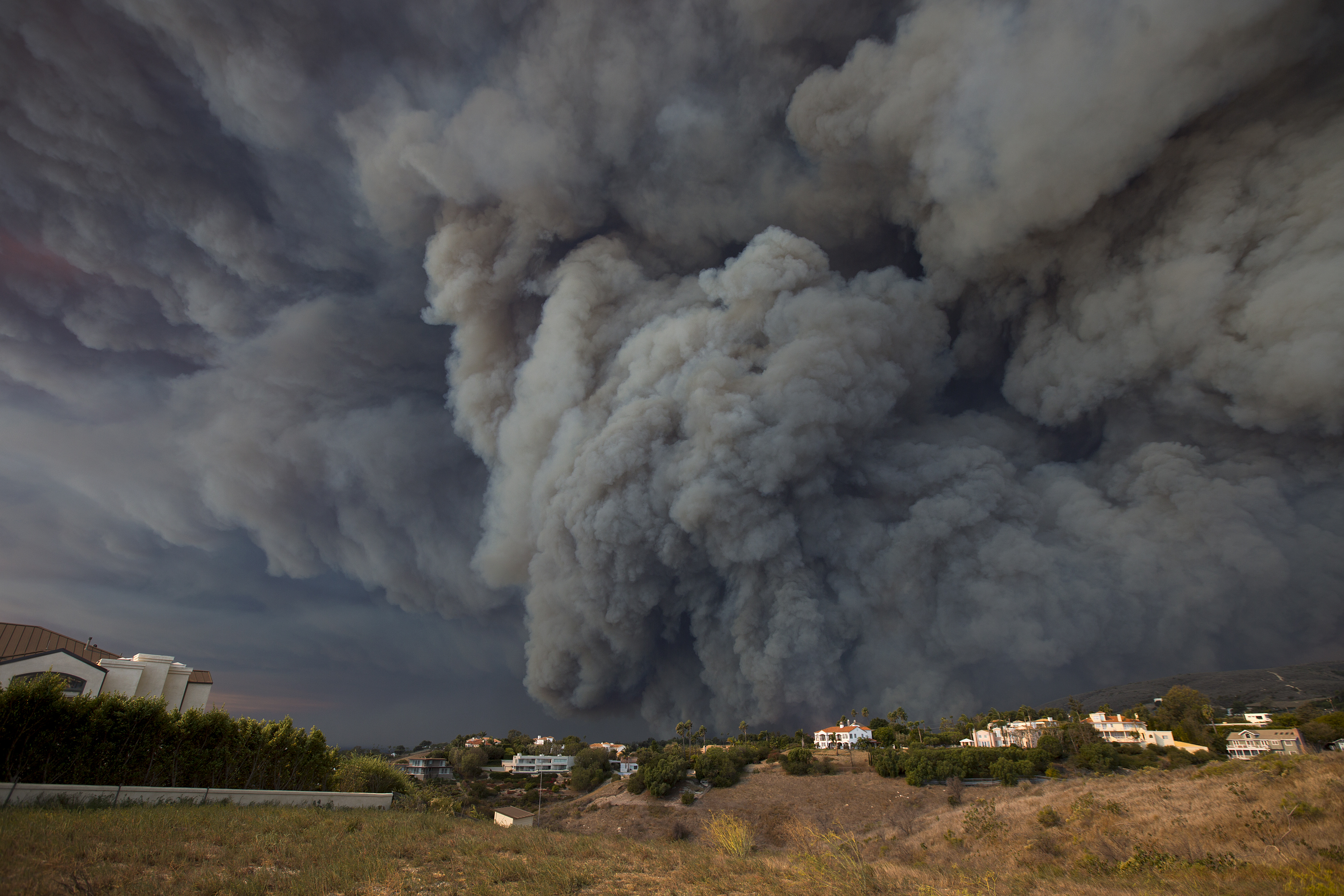 A massive smoke plume, powered by strong winds, rises above the the Woolsey Fire on November 9, 2018 in Malibu, California. CREDIT: David McNew/Getty Images