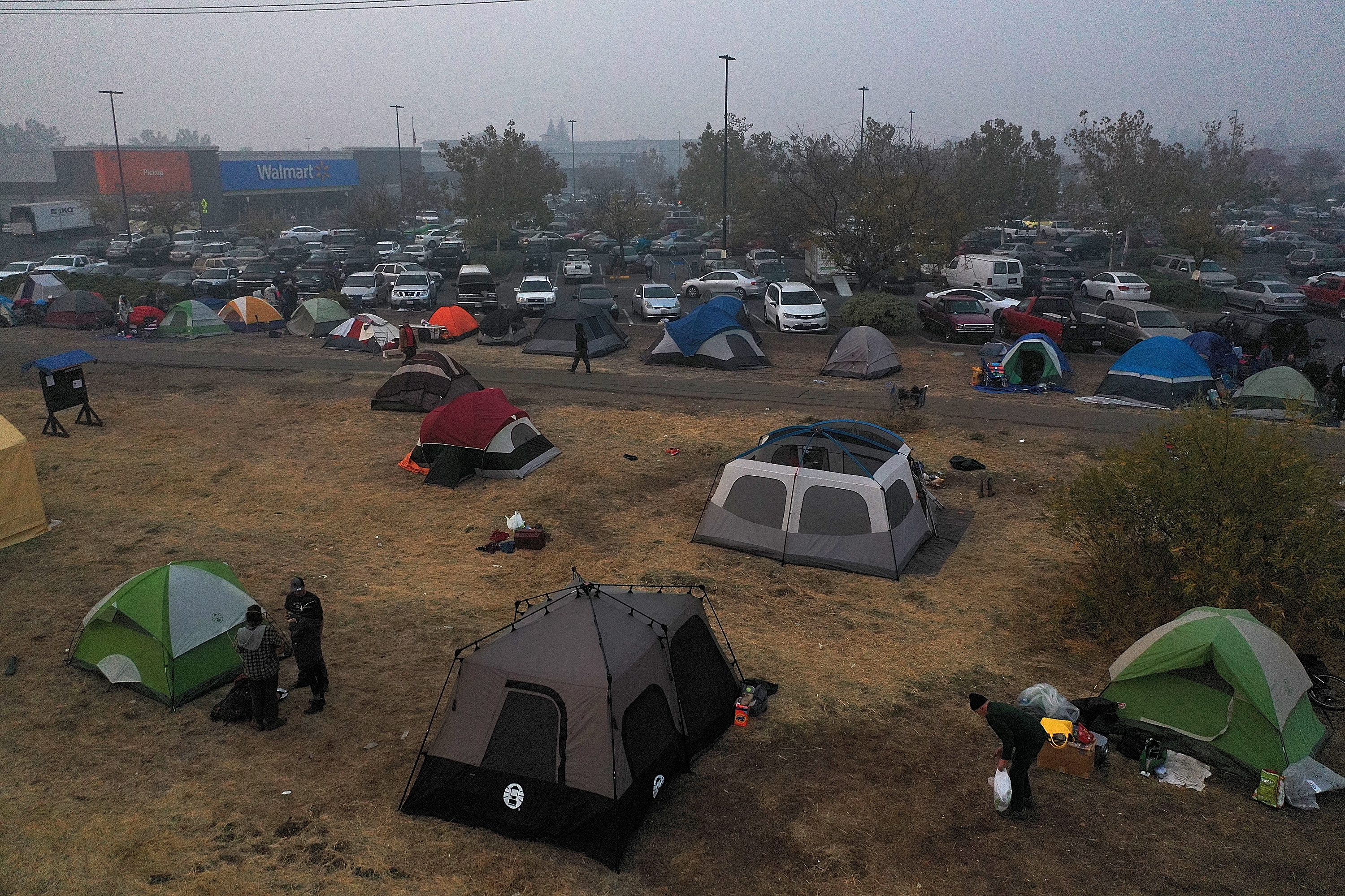 CHICO, CA - NOVEMBER 16: Tents are seen pitched in a field next to a Walmart parking lot where Camp Fire evacuees have been staying on November 16, 2018 in Chico, California. Fueled by high winds and low humidity the Camp Fire ripped through the town of Paradise charring over 140,000 acres, killed at least 63 people and has destroyed over 11,000 homes and businesses. The fire is currently at 45 percent containment and 631 people still remain missing. (Photo by Justin Sullivan/Getty Images)