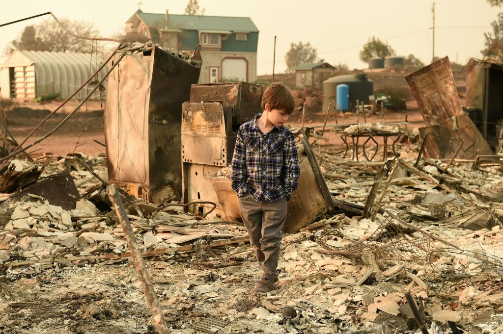 Jacob Saylors, 11, walks through the burned remains of his home in Paradise. (CREDIT: Josh Edelson / AFP / Getty Images)
