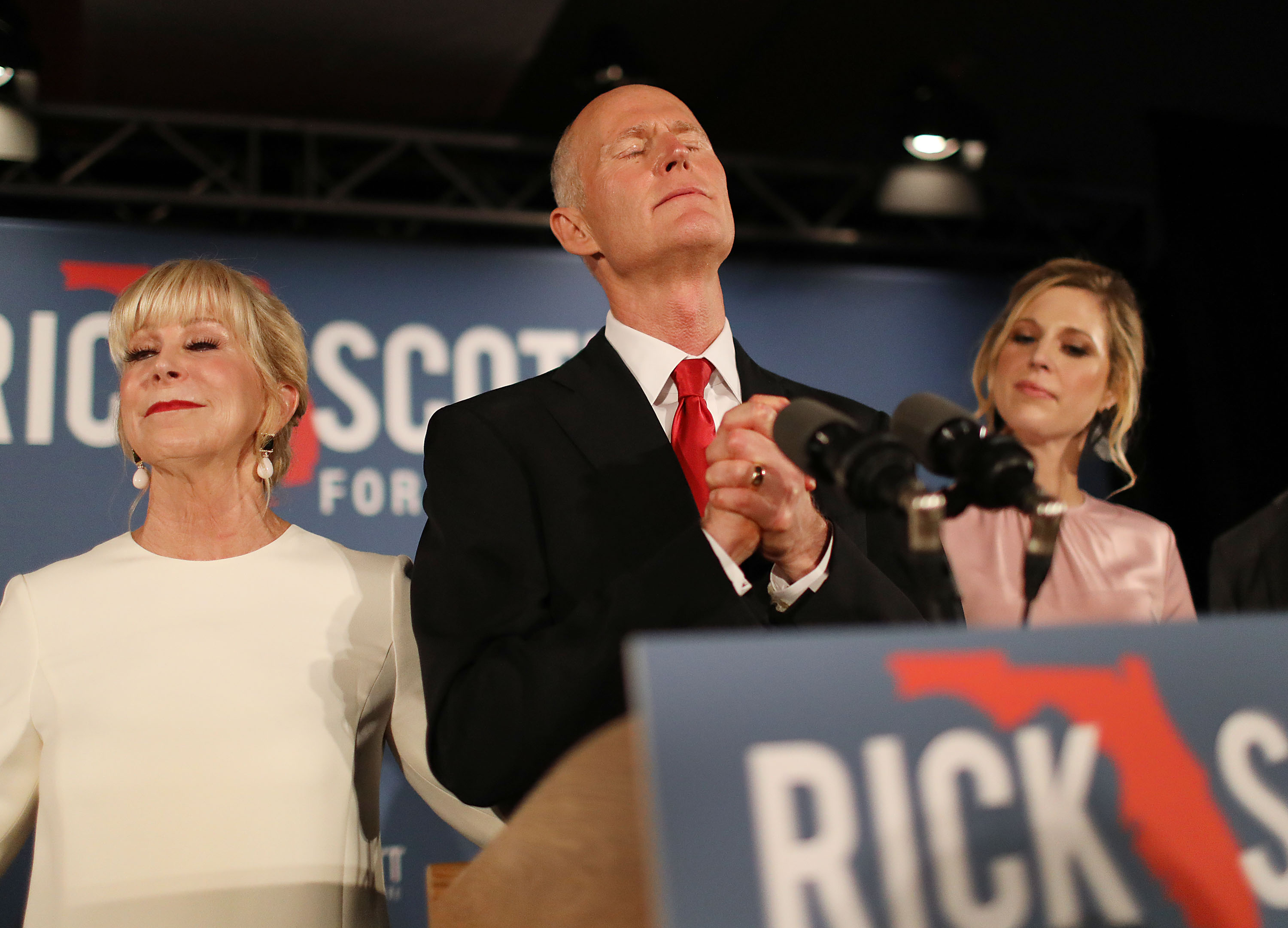 NAPLES, FLORIDA - NOVEMBER 06: Florida Governor Rick Scott pauses as he becomes emotional while speaking as he stands with his wife, Ann Scott, (L) and daughter Alison Guimard (R) during his election night party at the LaPlaya Beach & Golf Resort on November 06, 2018 in Naples, Florida. Governor Scott defeated Sen. Bill Nelson for the Florida Senate seat. (Photo by Joe Raedle/Getty Images)