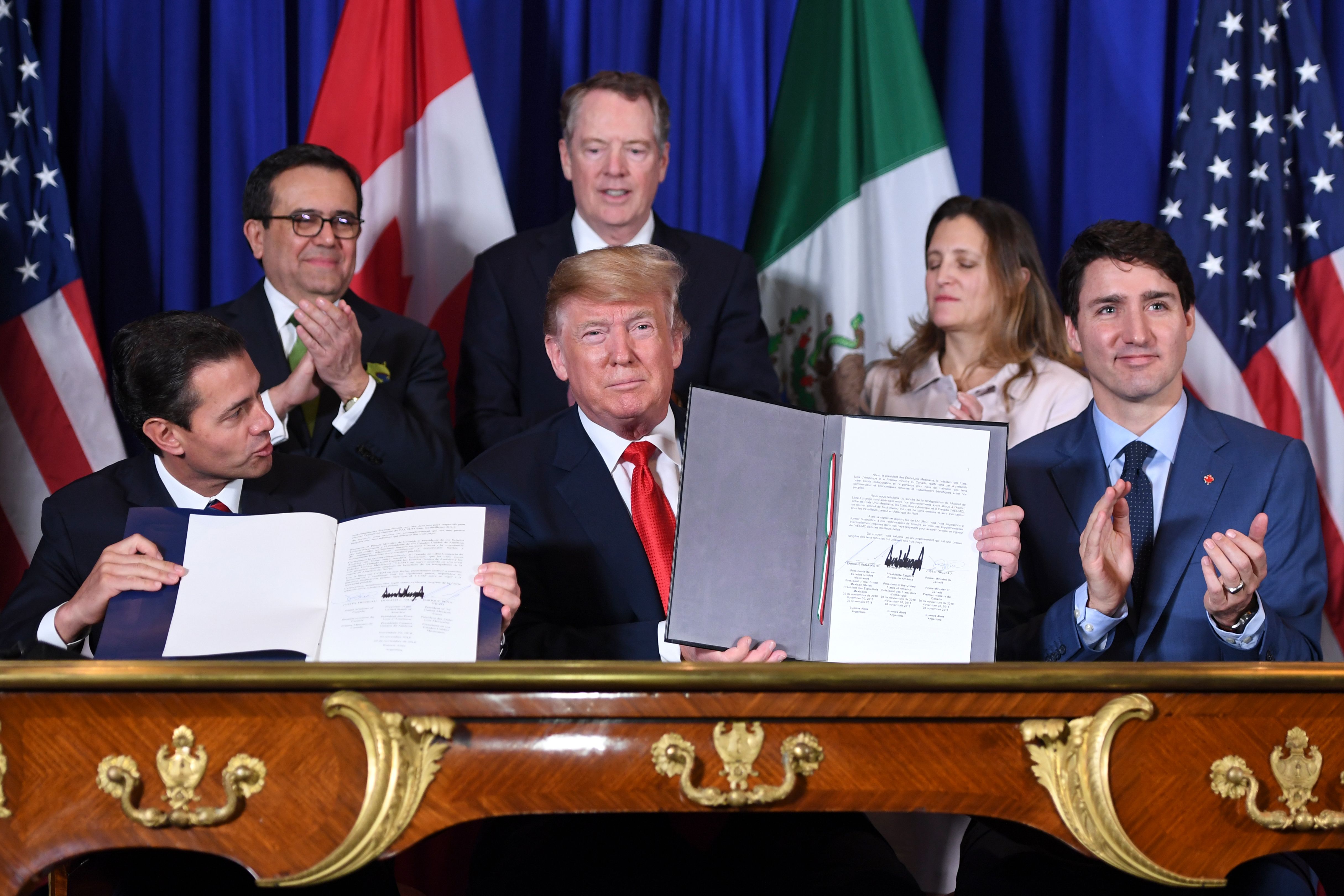 Mexico's President Enrique Pena Nieto,President Donald Trump, and Canadian Prime Minister Justin Trudeau, sign a new free trade agreement in Buenos Aires, on November 30, 2018, on the sidelines of the G20 Leaders' Summit. CREDIT: Saul Loeb/AFP/Getty Images.