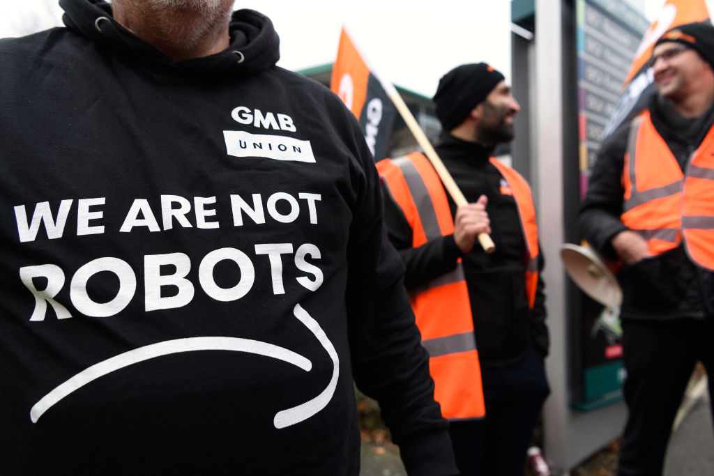 Members and supporters of the GMB union protest outside the Amazon offices as the company holds its annual Black Friday sales, on November 23, 2018 in Milton Keynes, England. Amazon workers in Italy and Spain are also expected to holds demonstrations for 24 hours in a joint protest against working conditions in the fulfillment centers of the online retail giant. (Photo credit: Leon Neal/Getty Images)