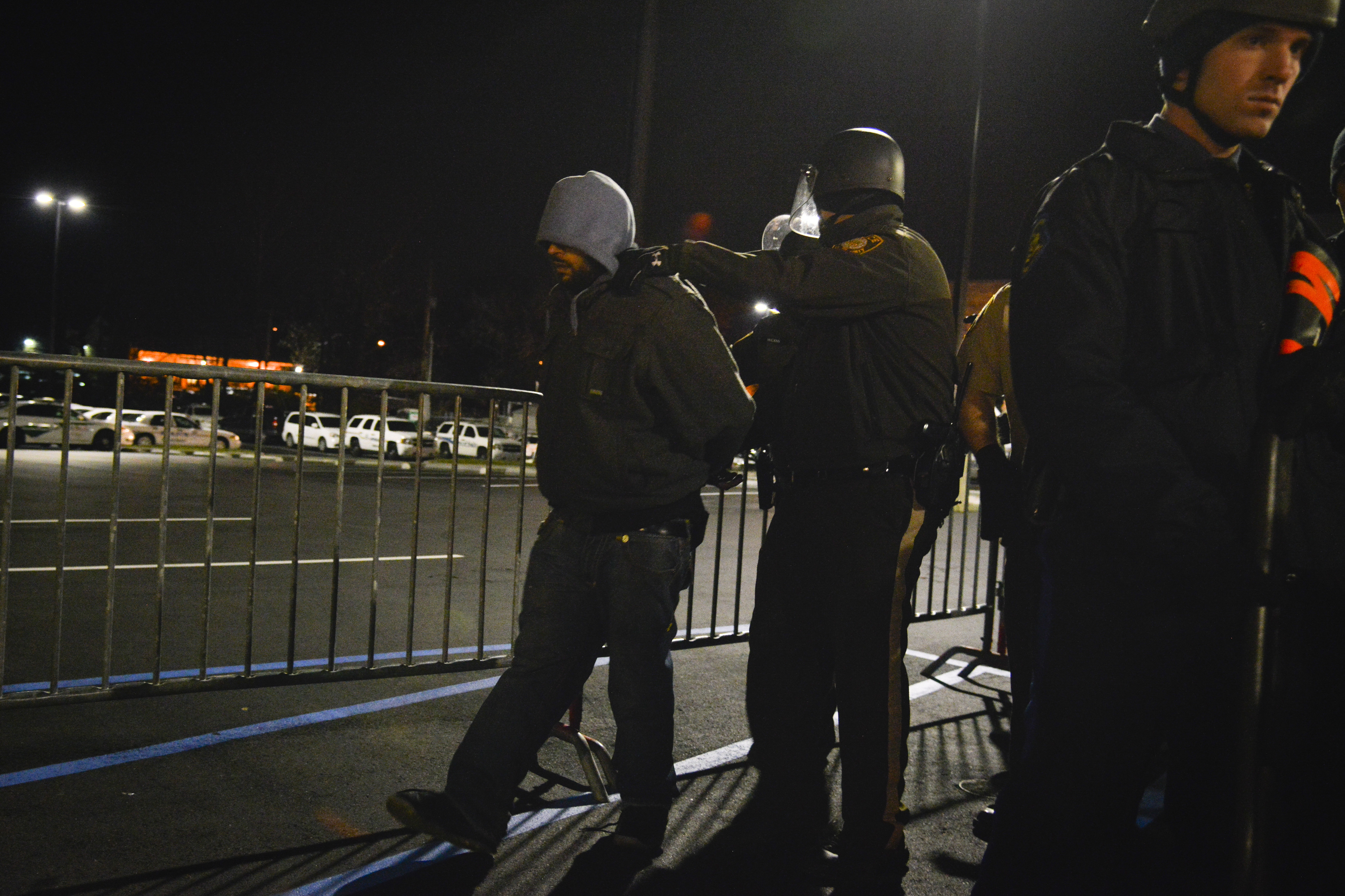 FERGUSON, MO - NOVEMBER 19:
Police officers arrest activist Bassem Masri as protesters gather in front of the Ferguson Police Department building on Wednesday, November 19, 2014, in Ferguson, MO. The shooting of Michael Brown, an unarmed black 18-year-old by white Ferguson police officer Darren Wilson, has captivated the nation as a grand jury deliberates to decide whether to charge the officer with a crime.
(Photo by Jahi Chikwendiu/The Washington Post via Getty Images)