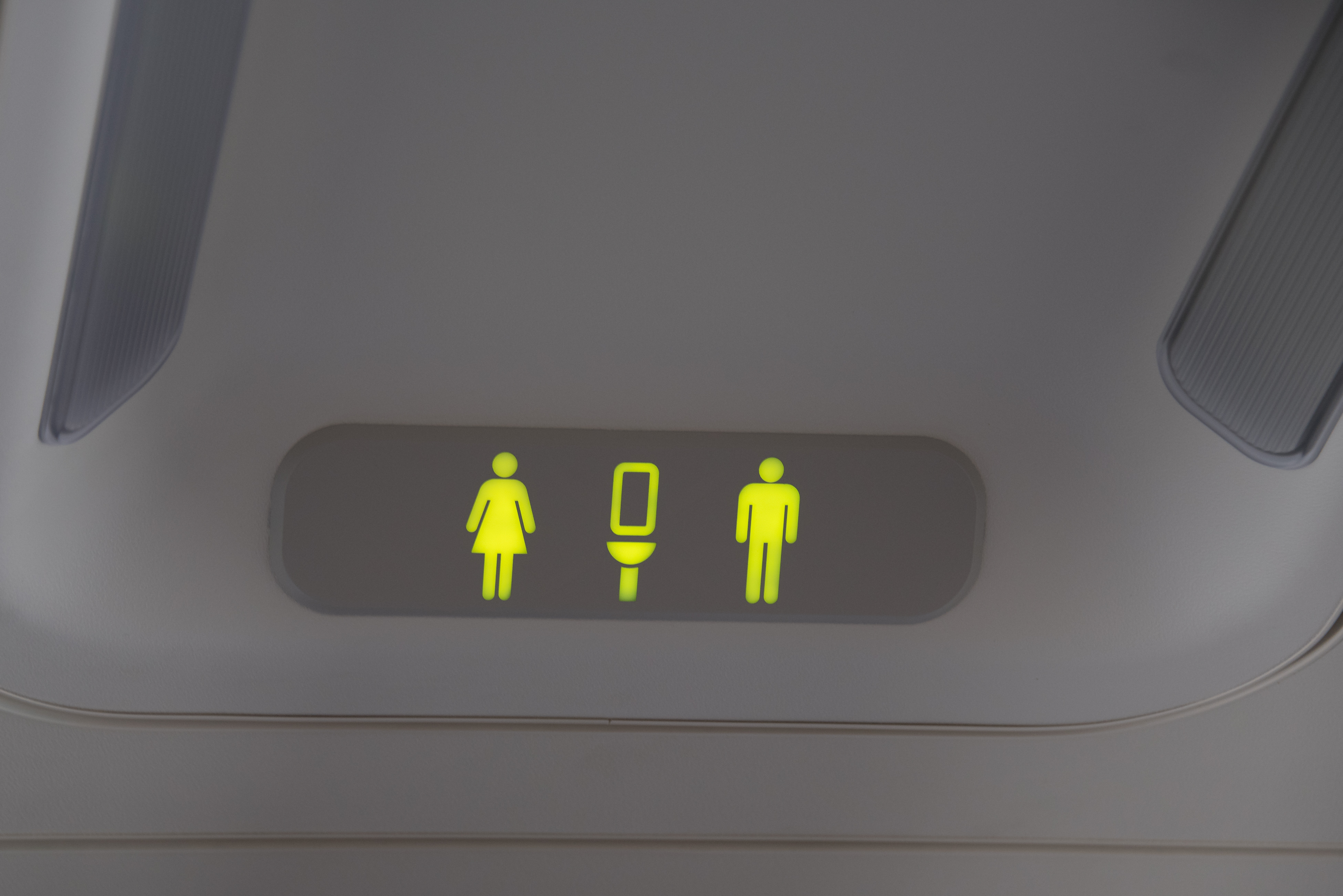 TORONTO, ONTARIO, CANADA - 2015/09/26: Lit on signal of bathrooms for men and women on a plane . (Photo by Roberto Machado Noa/LightRocket via Getty Images)