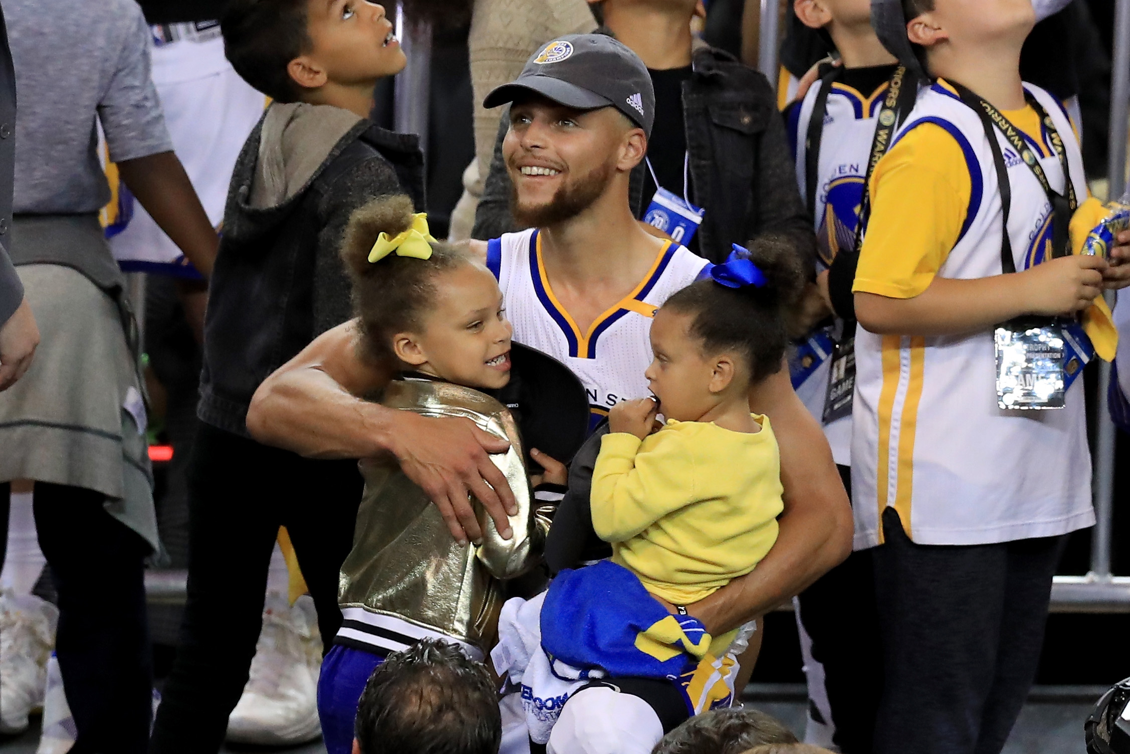 OAKLAND, CA - JUNE 12: Stephen Curry #30 of the Golden State Warriors celebrates holding his daughters Riley and Ryan after defeating the Cleveland Cavaliers 129-120 in Game 5 to win the 2017 NBA Finals at ORACLE Arena on June 12, 2017 in Oakland, California. NOTE TO USER: User expressly acknowledges and agrees that, by downloading and or using this photograph, User is consenting to the terms and conditions of the Getty Images License Agreement. (Photo by Ronald Martinez/Getty Images)
