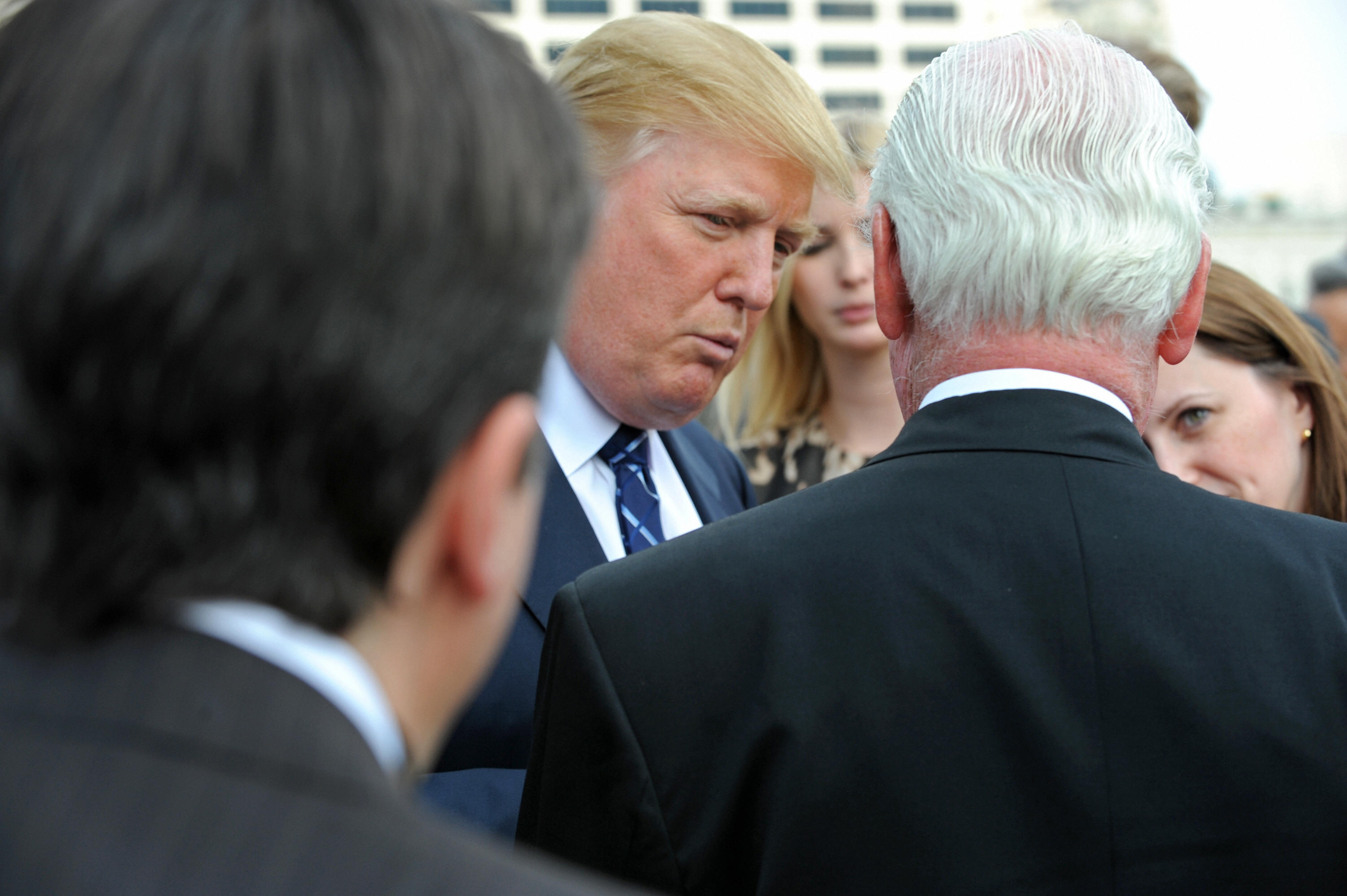 President Donald Trump, center, speaks with Chicago Alderman Ed Burke, right, after a press conference at the Trump International Hotel and Tower in Chicago on Sept. 24, 2008. CREDIT: Amanda Rivkin/AFP/Getty Images