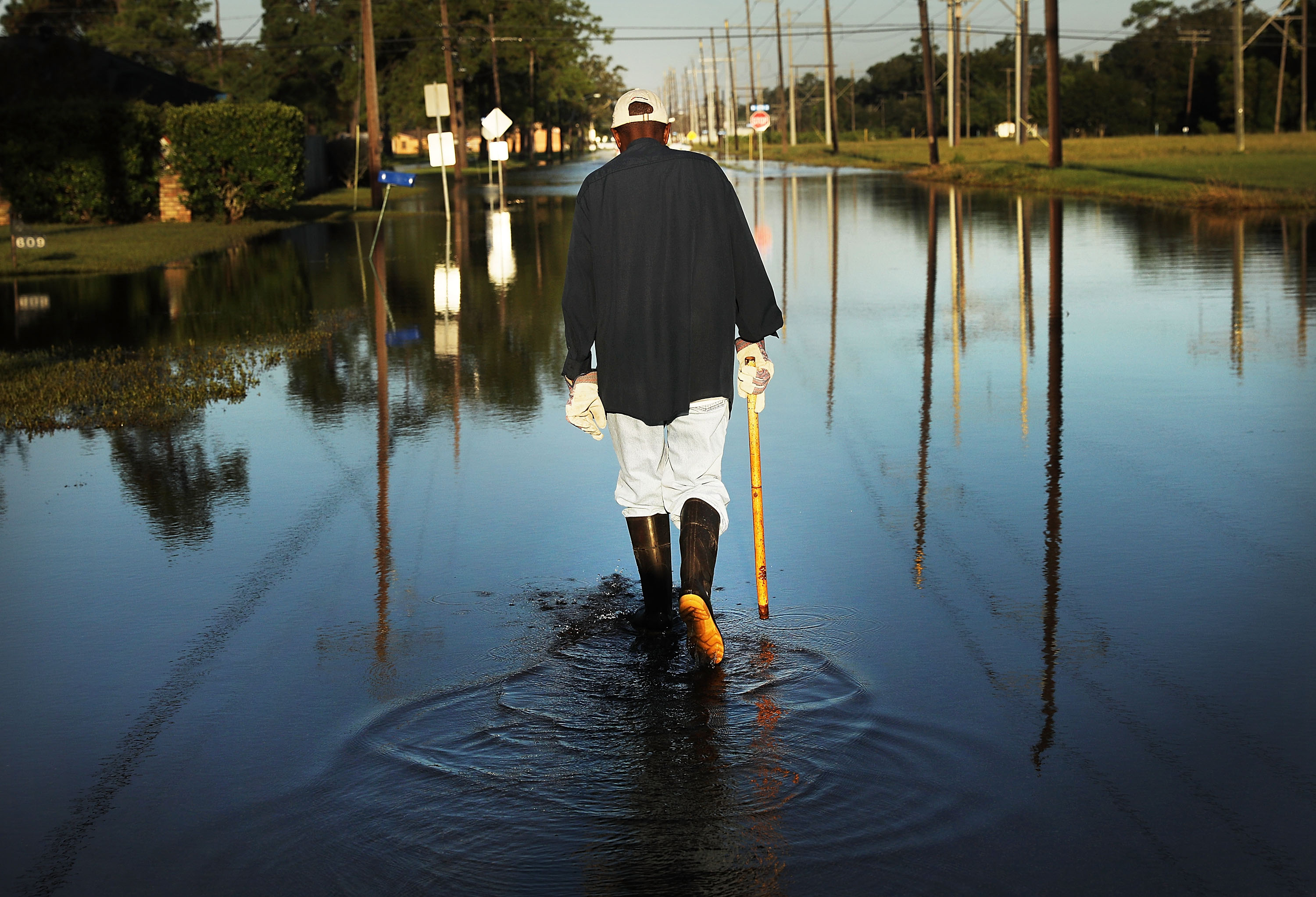 Paul Morris checks on neighbors homes in a flooded district of Orange as Texas slowly moves toward recovery from the devastation of Hurricane Harvey on September 7, 2017 in Orange, Texas. CREDIT: Spencer Platt/Getty Images