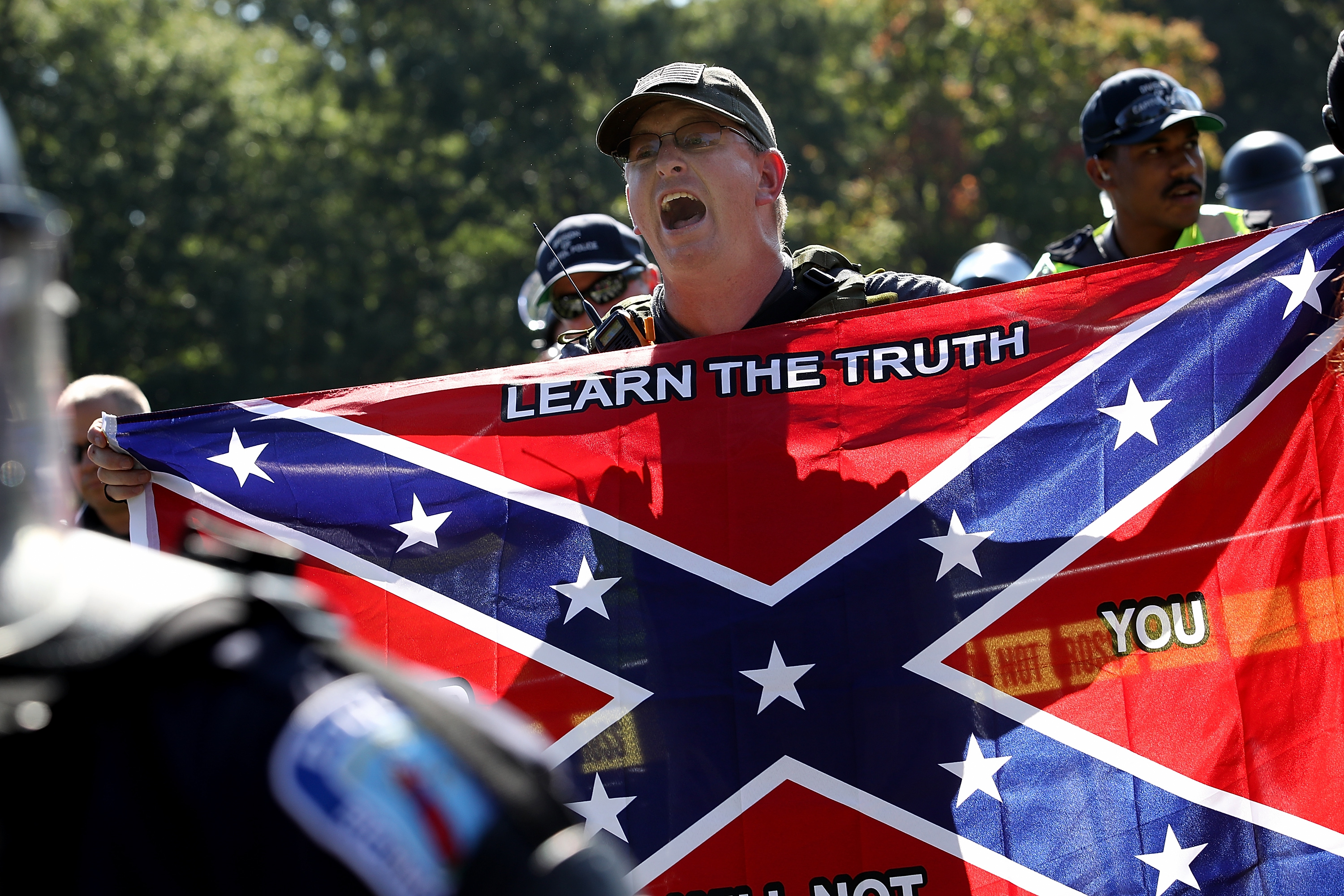 The "NO HATE Act" aims to increase reporting and transparency around hate crime acts, like those committed by white supremacist neo-Confederates. CREDIT: WIN MCNAMEE / GETTY