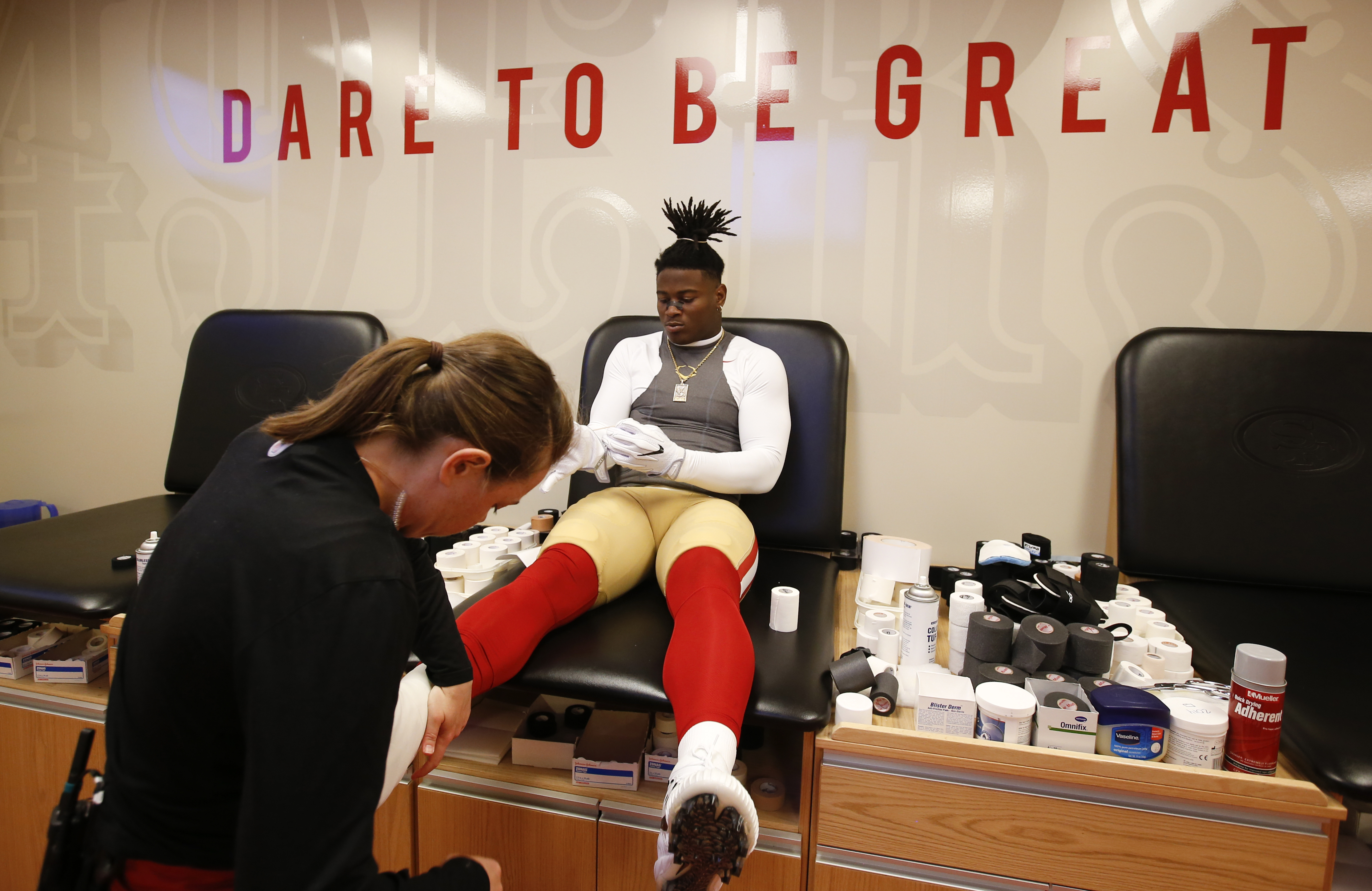 SANTA CLARA, CA - NOVEMBER 5: Assistant Head Athletic Trainer Laura Schnettgoecke of the San Francisco 49ers tapes up Reuben Foster #56 in the locker room prior to the game against the Arizona Cardinals at Levi's Stadium on November 5, 2017 in Santa Clara, California. The Cardinals defeated the 49ers 20-10. (Photo by Michael Zagaris/San Francisco 49ers/Getty Images)