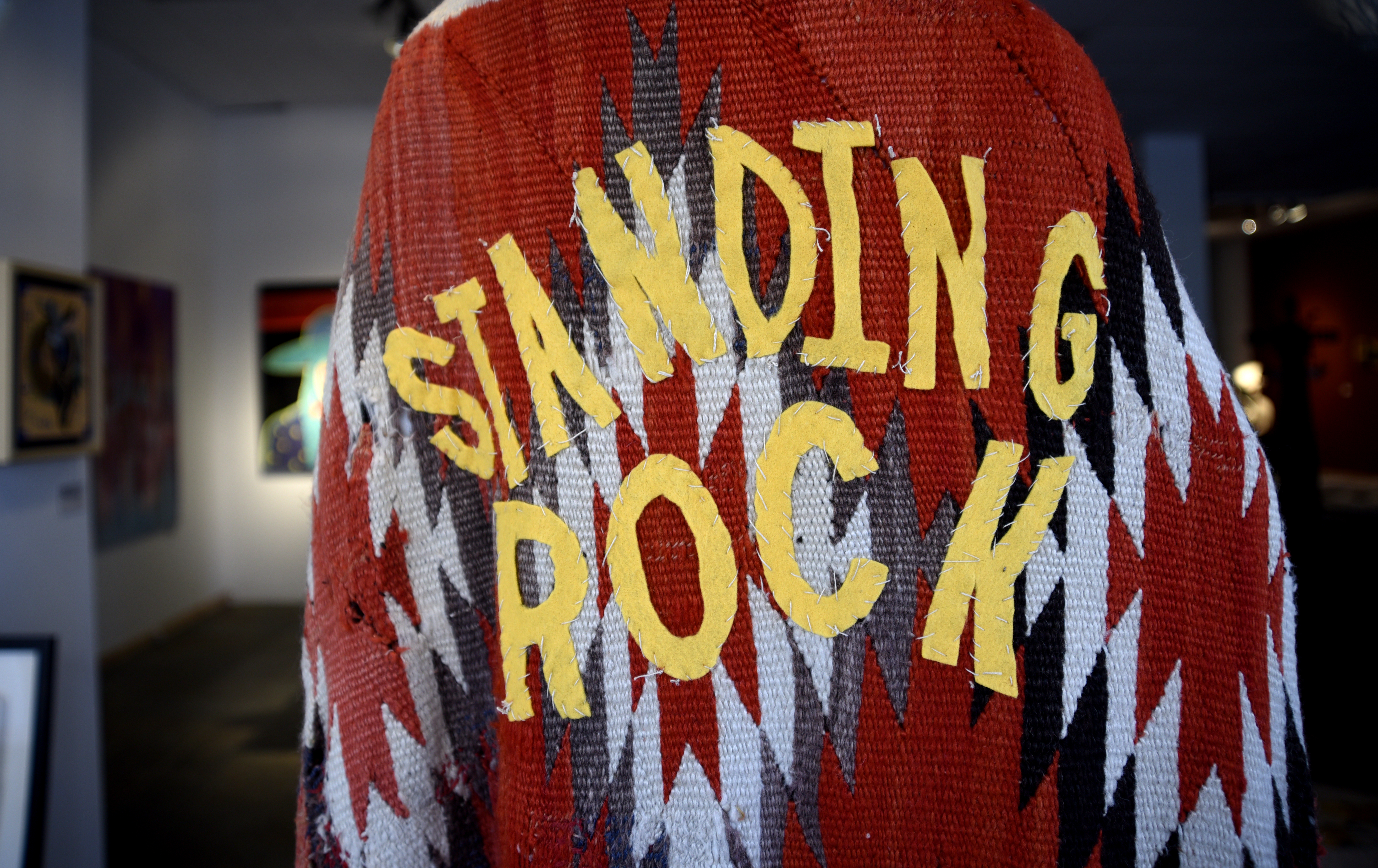 SANTA FE, NM - NOVEMBER 12, 2017: A coat made from an antique blanket for sale in a Santa Fe, New Mexico, art gallery is embellished with cutout letters spelling 'Standing Rock', referring to the Standing Rock Indian Reservation in North and South Dakota. (Photo by Robert Alexander/Getty Images)