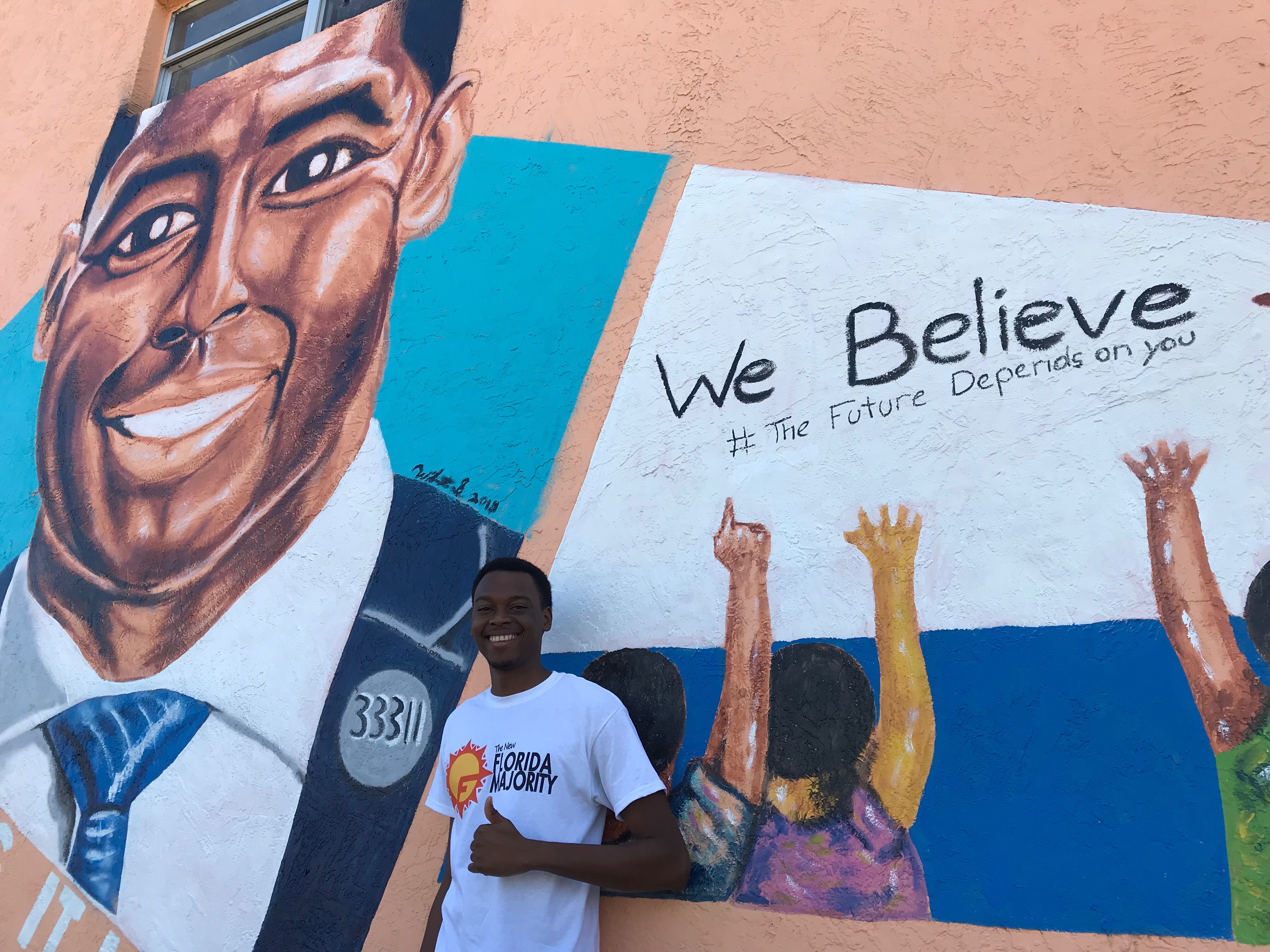Easton Harrison in front of a pro-Gillum Mural (Credit: Luke Barnes for ThinkProgress)