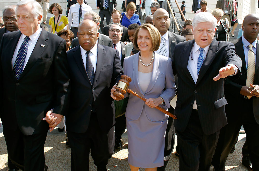 Nancy Pelosi carries the gavel that was used to pass Medicare in 1965 while marching with John Lewis, Steny Hoyer, John Larson, and other House Democrats before the final Obamacare vote on March 21, 2010. (Chip Somodevilla/Getty Images)