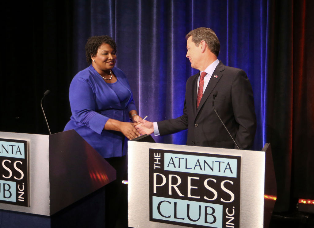 Stacey Abrams and Brian Kemp shake hands before a debate in Atlanta, Georgia on October 23, 2018. (John Bazemore-Pool/Getty Images)