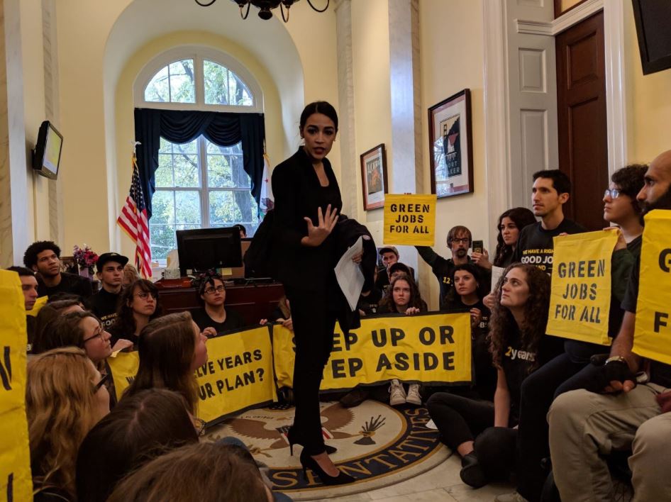 Alexandria Ocasio-Cortez, a congressmember-elect from New York City, joins protesters in the office of Rep. Nancy Pelosi (D-CA) on November 13, 2018. CREDIT: Sunrise Movement