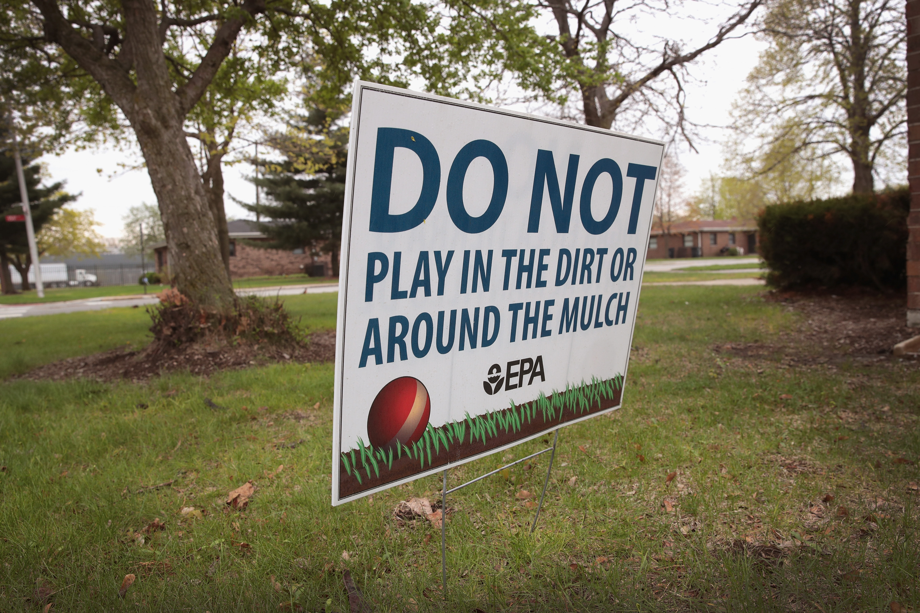 A sign, placed by the EPA, warns people not to play on the lawn at the West Calumet Housing Complex, an EPA Superfund site, on April 19, 2017 in East Chicago, Indiana. CREDIT: Scott Olson/Getty Images