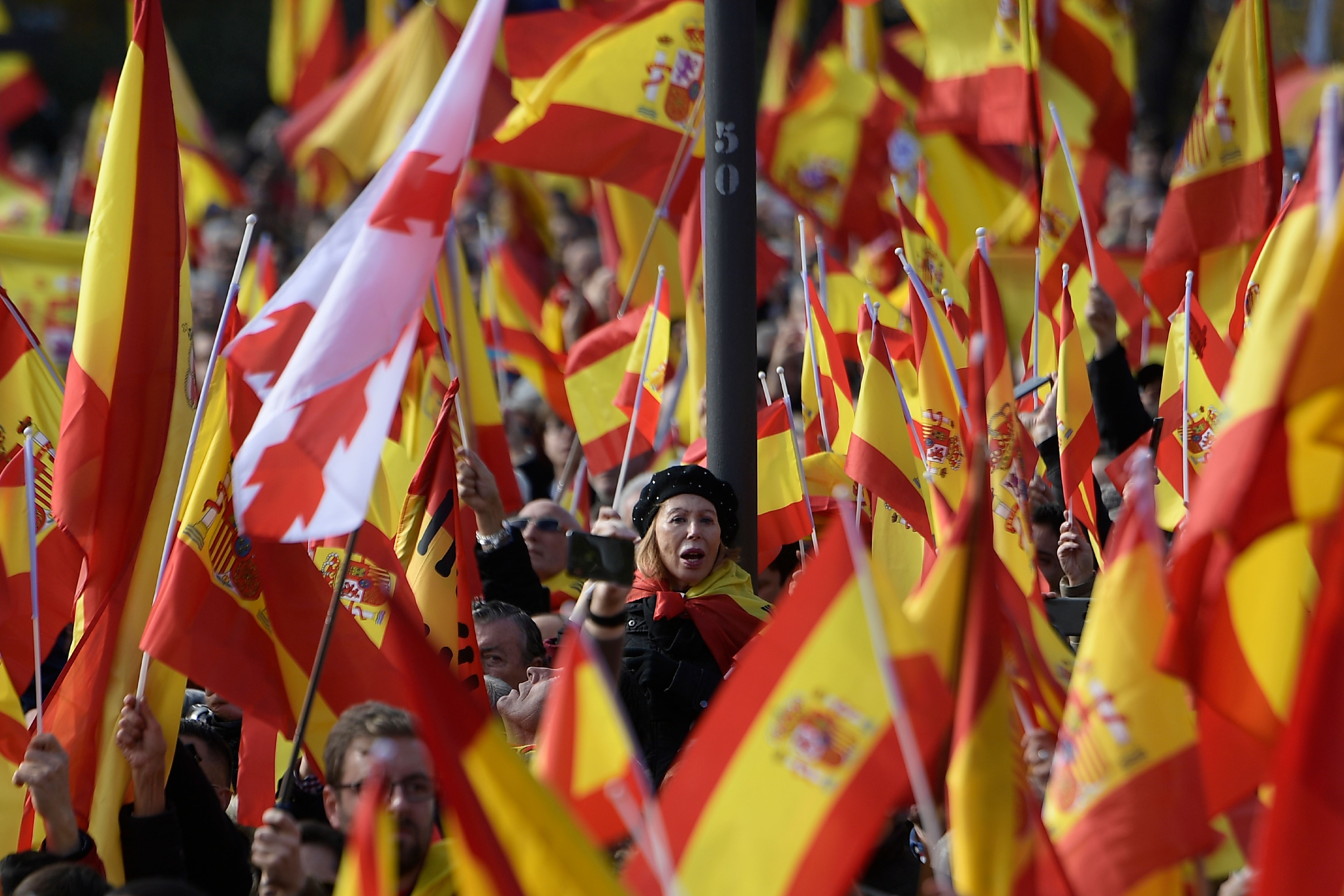 People hold Spanish flags during a demonstration called by the far-right party VOX against Catalan separatists on December 1, 2018 in Madrid. (Photo by OSCAR DEL POZO / AFP) (Photo credit should read OSCAR DEL POZO/AFP/Getty Images)