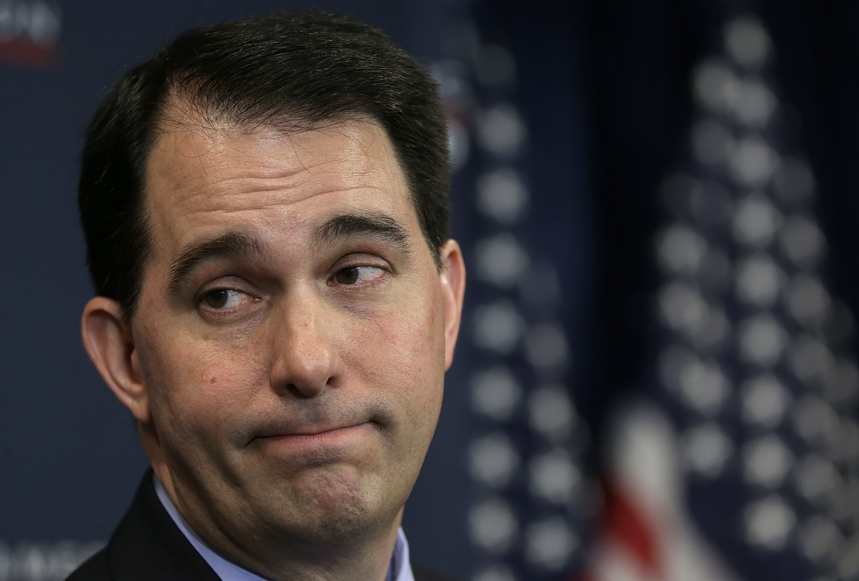 Gov. Scott Walker (R) signed into law a package of bills aimed at undermining his successor Friday. (PHOTO CREDIT: Win McNamee/Getty Images)