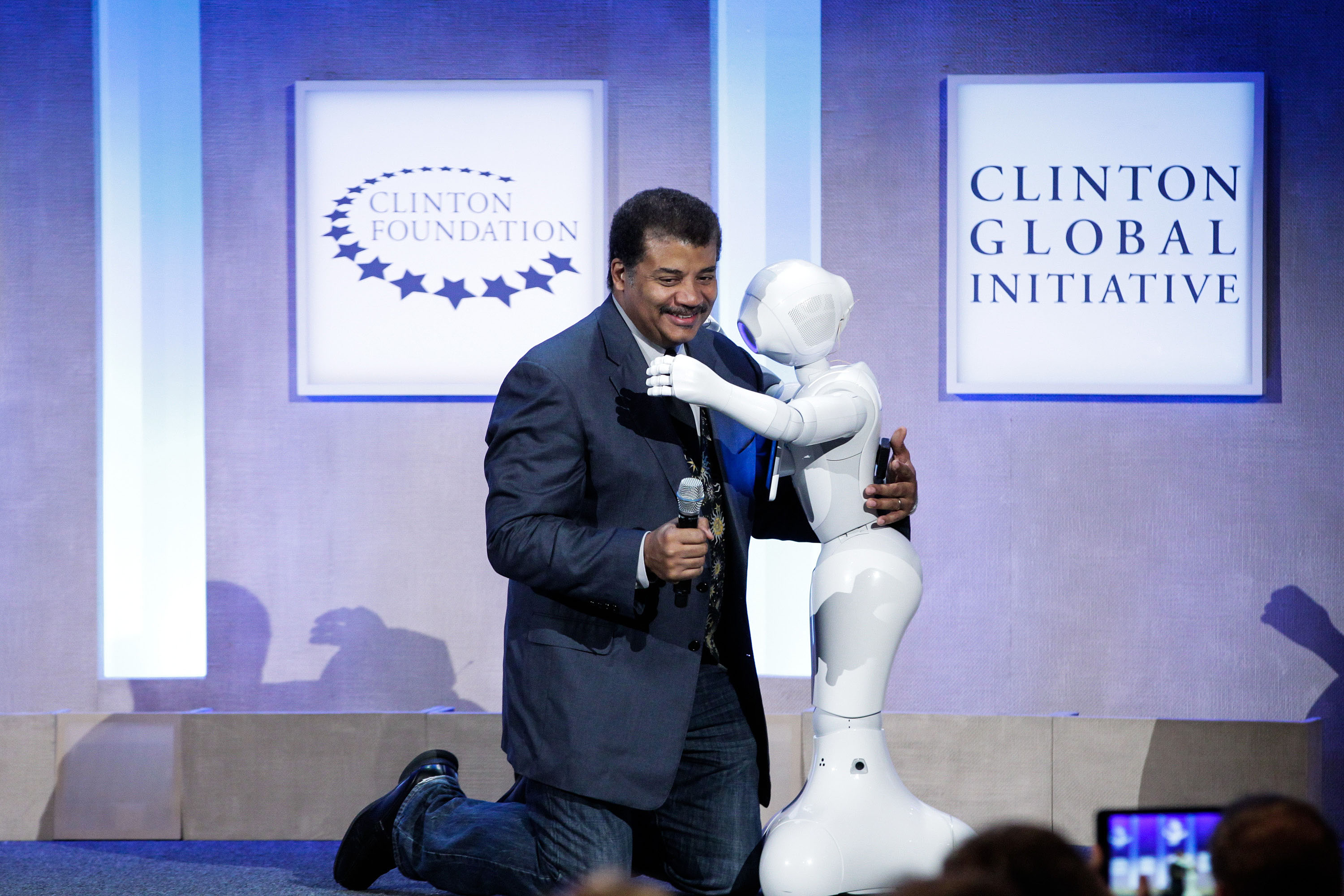NEW YORK, NY - SEPTEMBER 28: Neil deGrasse Tyson, Astrophysicist, American Museum of Natural History hugs Pepper, Social Humanoid Robot at the Looking to the Next Frontier session during the third day of the 2015 Clinton Global Initiative's Annual Meeting at the Sheraton New York Hotel & Towers on September 28, 2015 in New York City. (Photo by JP Yim/Getty Images)