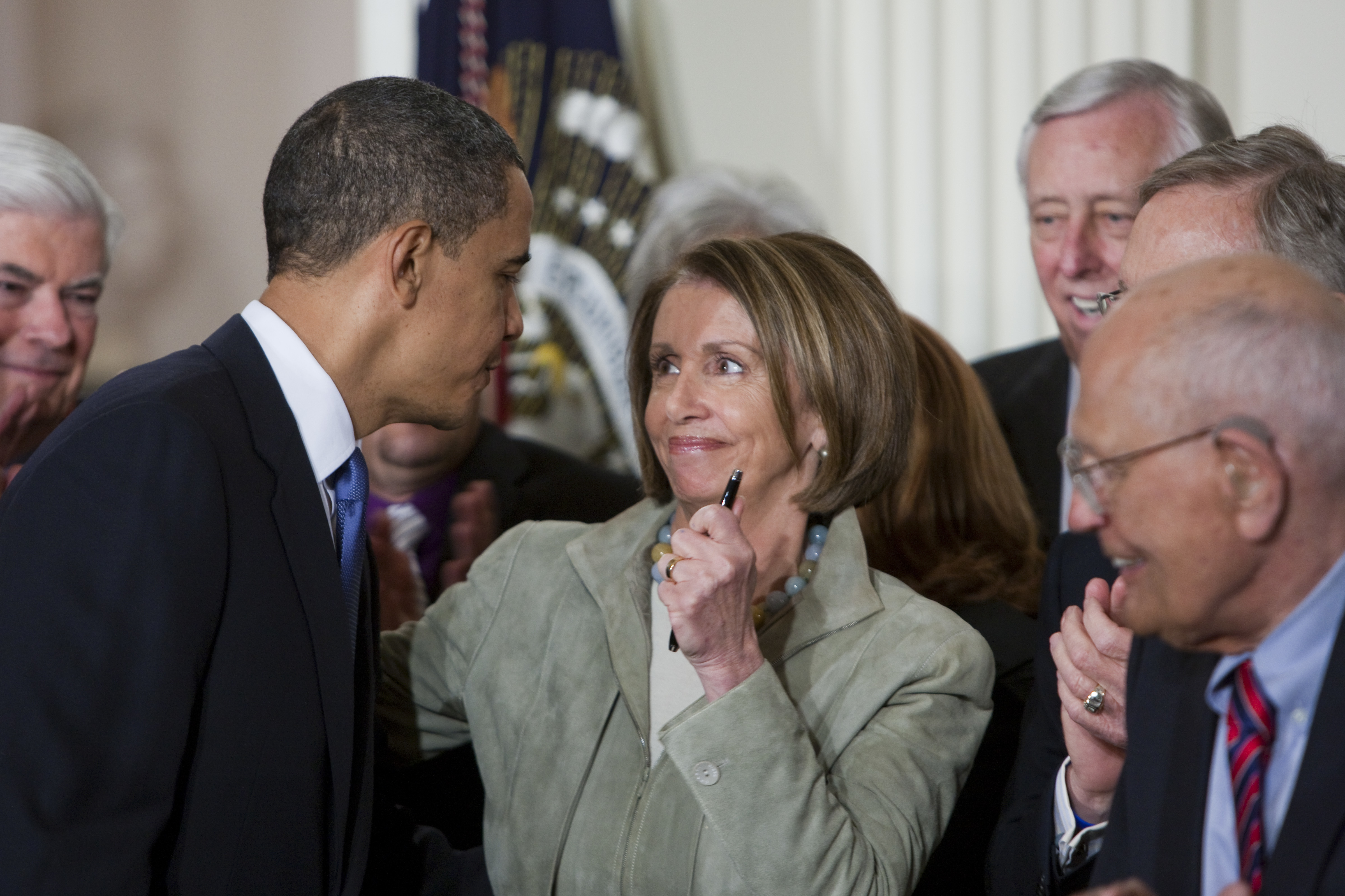President Barack Obama greets House Speaker Nancy Pelosi (D-CA) after Obama signed comprehensive healthcare reform legislation during a ceremony in the East Room of the White House in Washington. (Photo by Brooks Kraft LLC/Corbis via Getty Images)