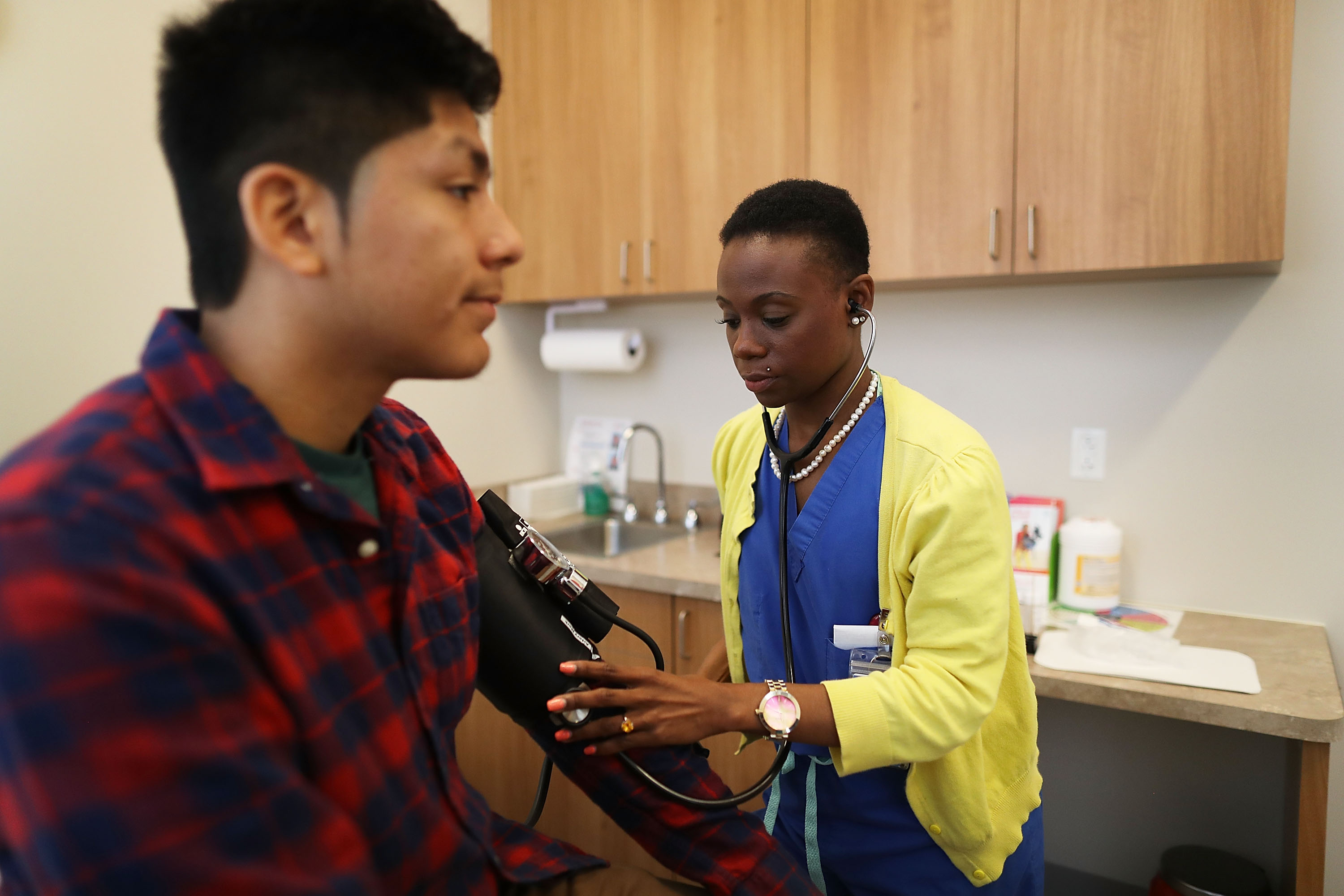MIAMI, FL - MAY 12: Peter Yanez, who is insured under a policy from the Affordable Care Act, has his blood pressure measured by Linda Williams, a medical assistant, before getting a blood test at a Planned Parenthood health center on May 12, 2017 in Miami, Florida. A GOP plan to repeal the Affordable Care Act would cut federal funding for Planned Parenthood services at their health centers. Planned Parenthood has approximately 700 health centers across the country that serve 2,470,000 male and female patients and provide services for preventive health care, birth-control, cancer screeening, pregnancy tests and STD testing and treatment. (Photo by Joe Raedle/Getty Images)