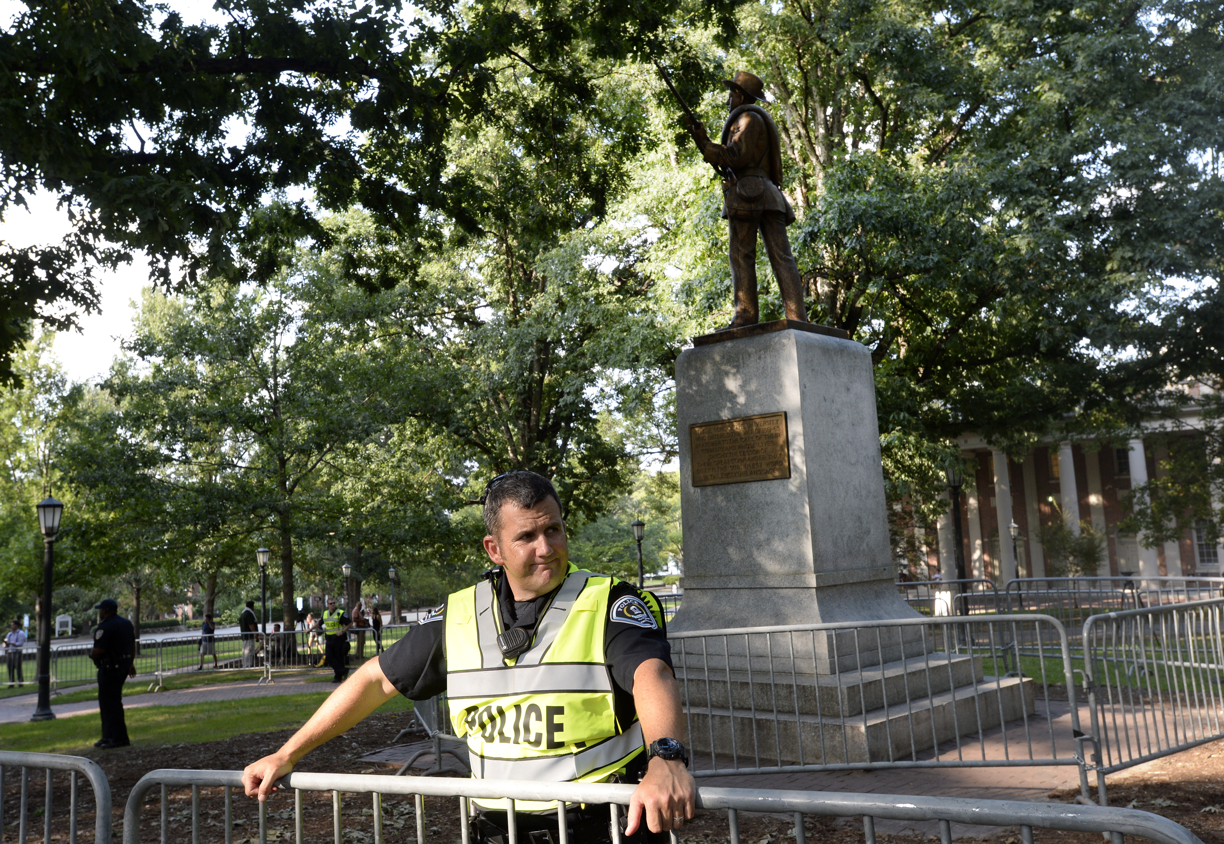 A Confederate statue, coined Silent Sam, is seen here under guard on the campus of the University of North Carolina in the days before protesters tore it from its pedestal. (Photo by Sara D. Davis/Getty Images)