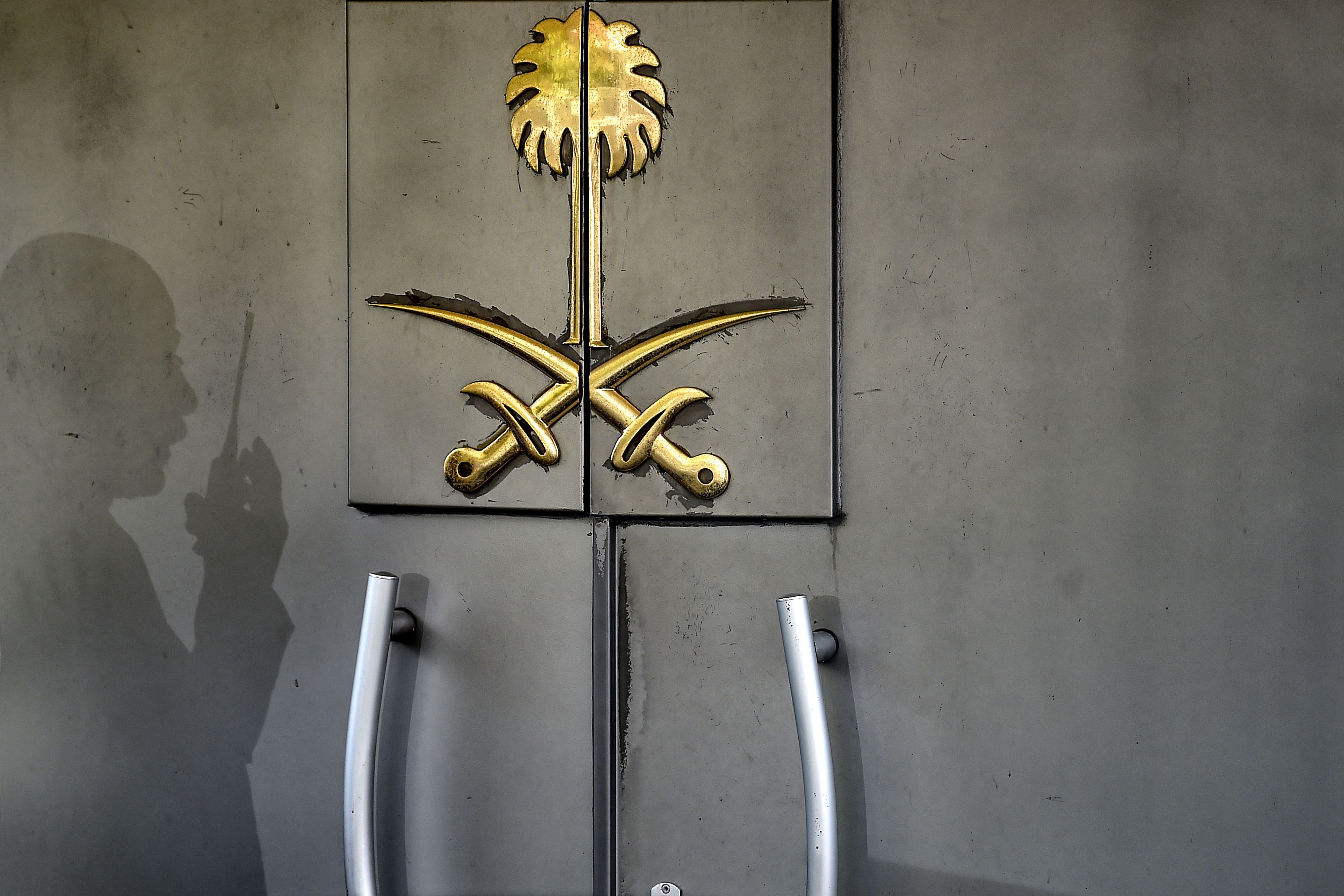 A shadow of a security member of the consulate is seen on the door of the Saudi Arabian consulate in Istanbul, where journalist Jamal Khashoggi was killed on Oct. 2, 2018. CREDIT: Ozan Kose/AFP/Getty Images.