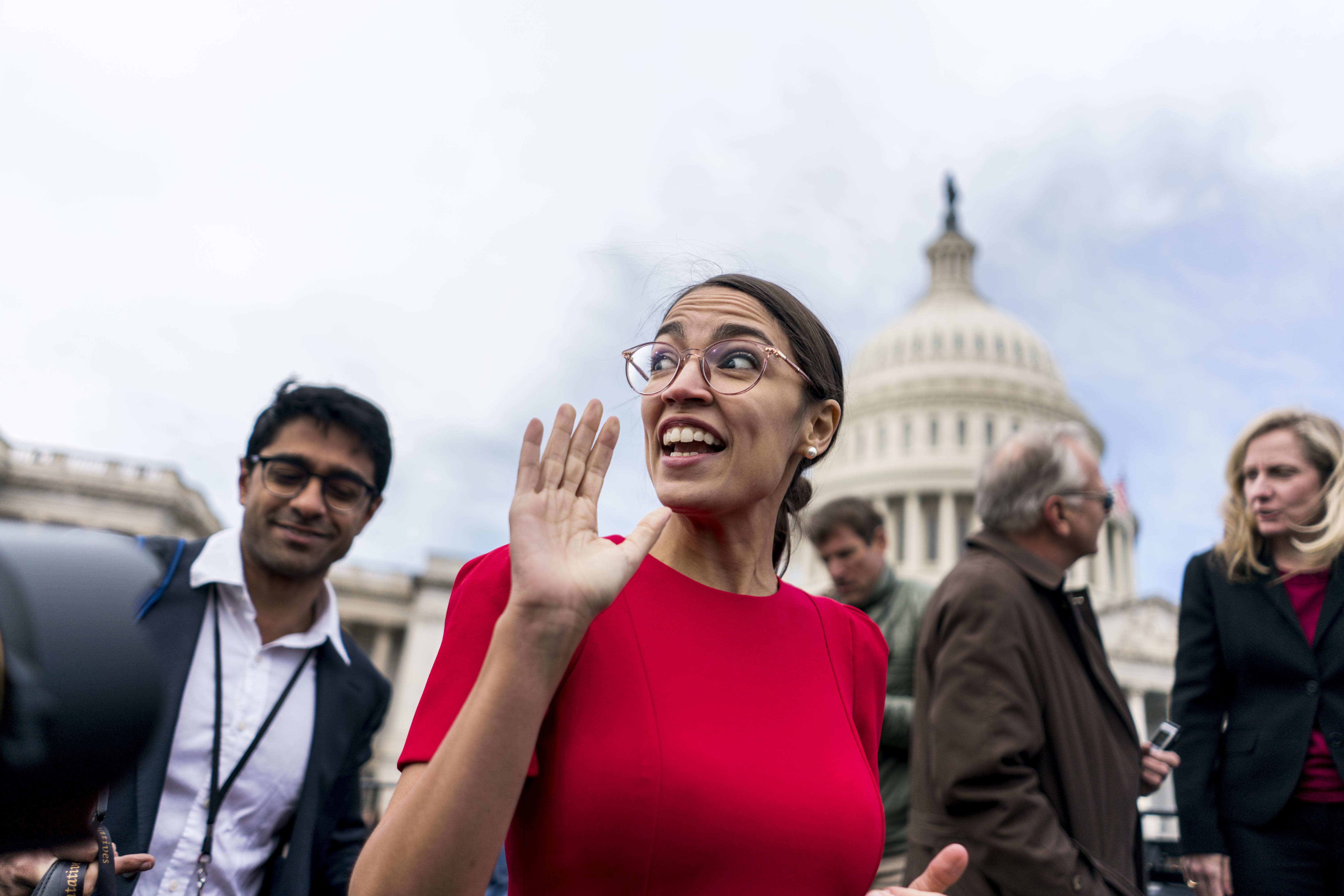 WASHINGTON, DC - On the US Capitol east front plaza 116th Congressional freshman Representatives, like Alexandria Ocasio-Cortez (D-NY), rush off after the Member-Elect class photo on the Capitol Hill in Washington, DC on Wednesday November 14, 2018. (Photo by Melina Mara/The Washington Post via Getty Images)