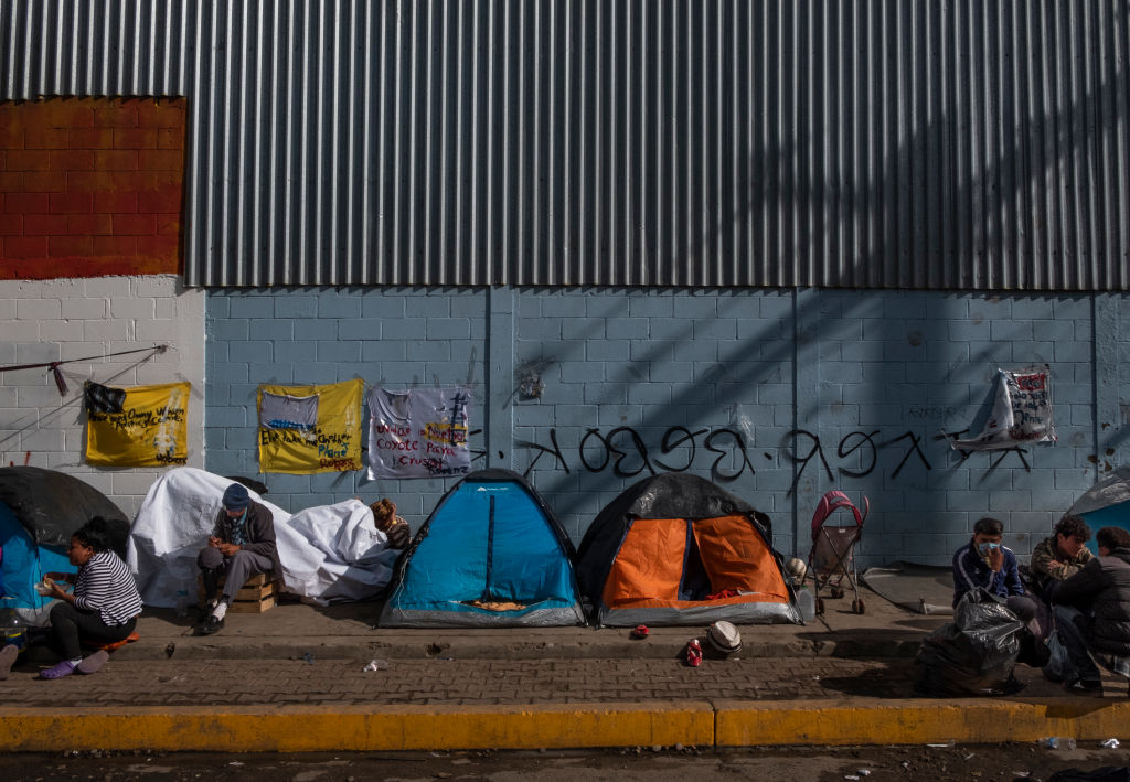 'Remain in Mexico' policy could also be the Trump administration's most dangerous. Pictured: South American migrants settle in the Benito Juarez Sports Complex area near the US border crossing of San Ysidro. December 1, 2018. (Photo credit: John Fredricks/NurPhoto via Getty Images)