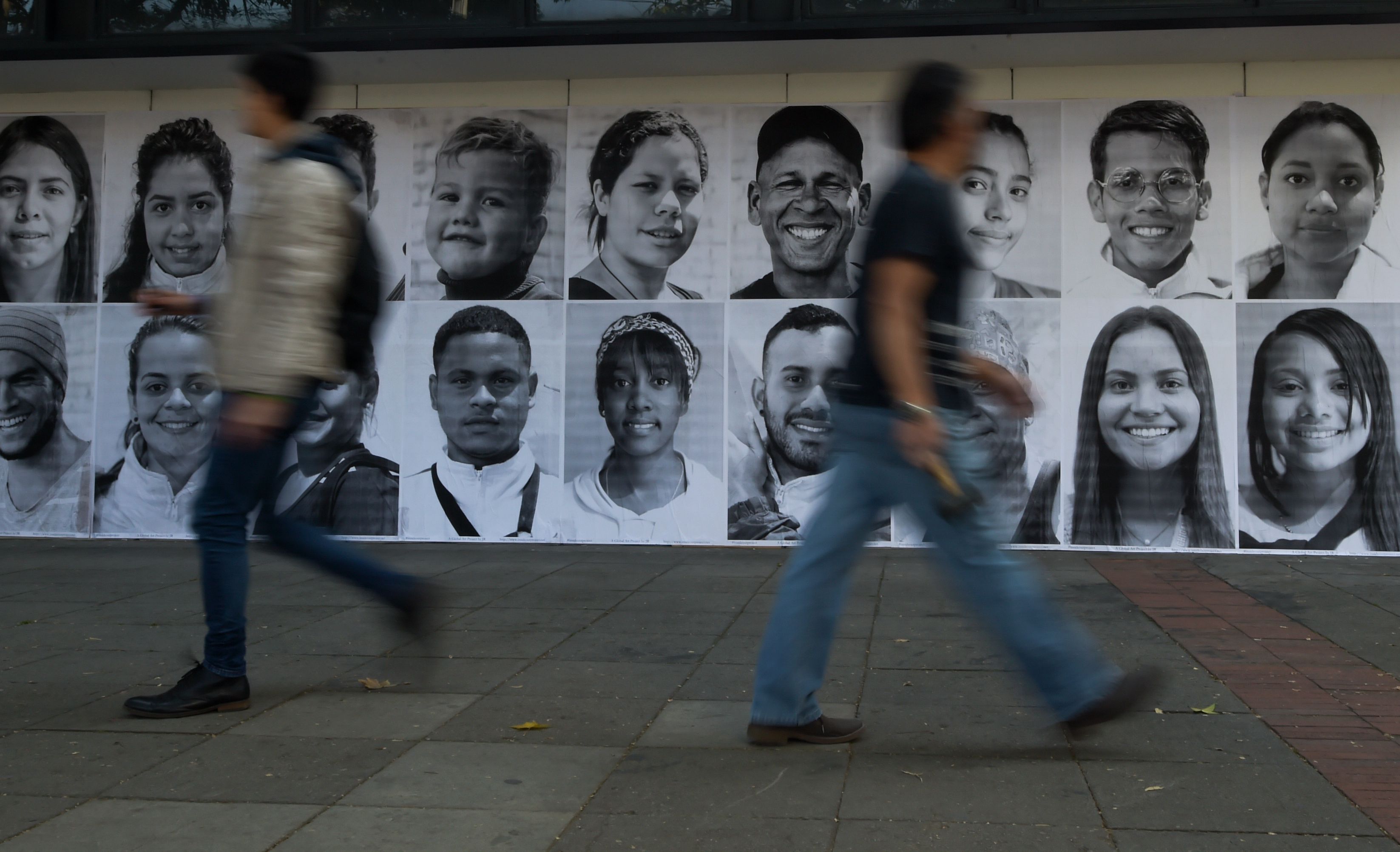 Portraits of Venezuelan migrants and refugees are displayed in Bogota as part of a campaign organized by several NGOs with the aim of giving visibility and face to people in migratory condition, on December 18, 2018. (Credit: Raul ARBOLEDA / AFP)