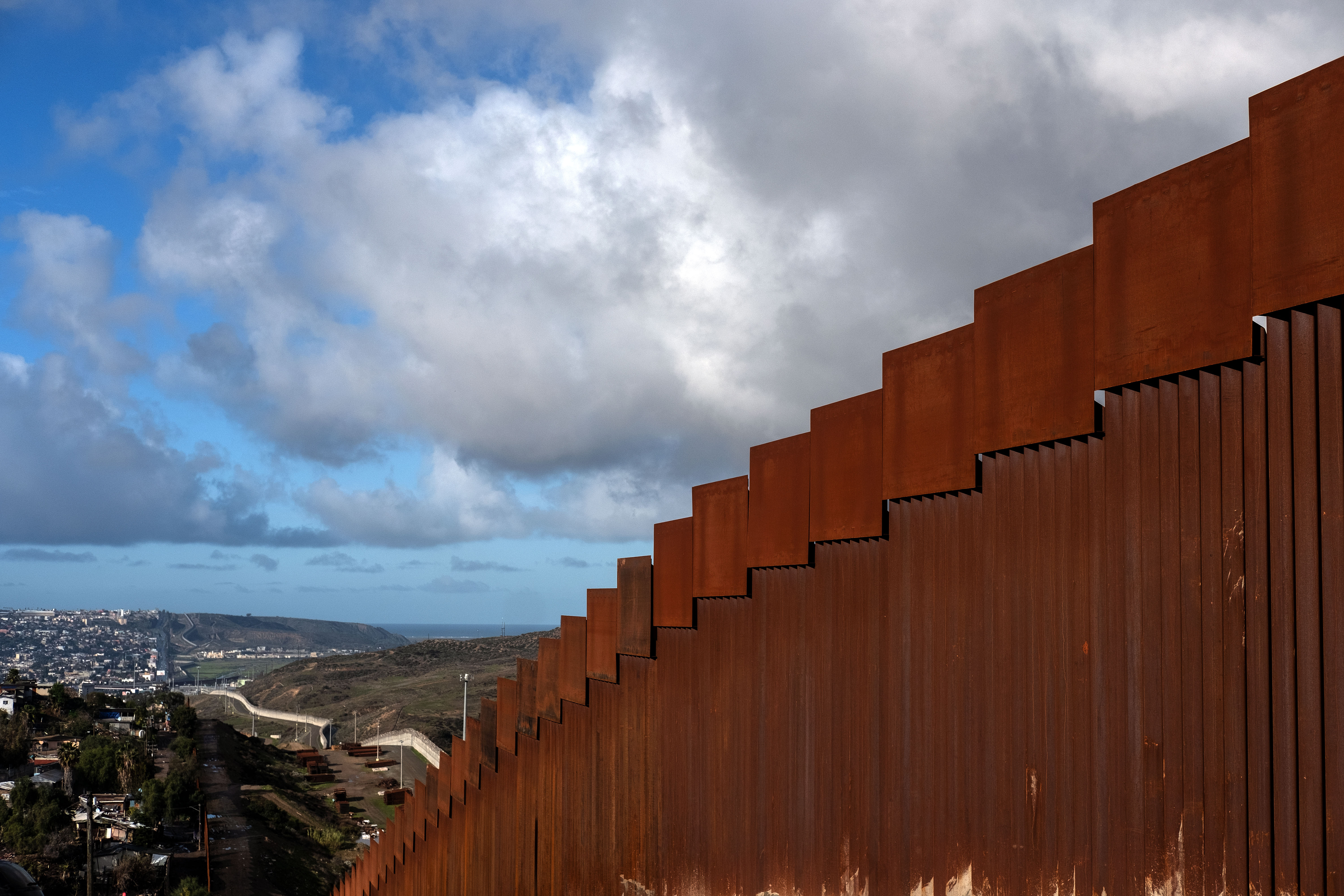 A section of the reinforced US - Mexico border fence on the Otay Mesa area, San Diego County, as seen from Tijuana, in Baja California state, Mexico. "We have to build the wall," Trump told reporters as he left the White House for the Camp David presidential retreat, while conceding that the barrier could be "steel instead of concrete." (Photo by GUILLERMO ARIAS/AFP/Getty Images)