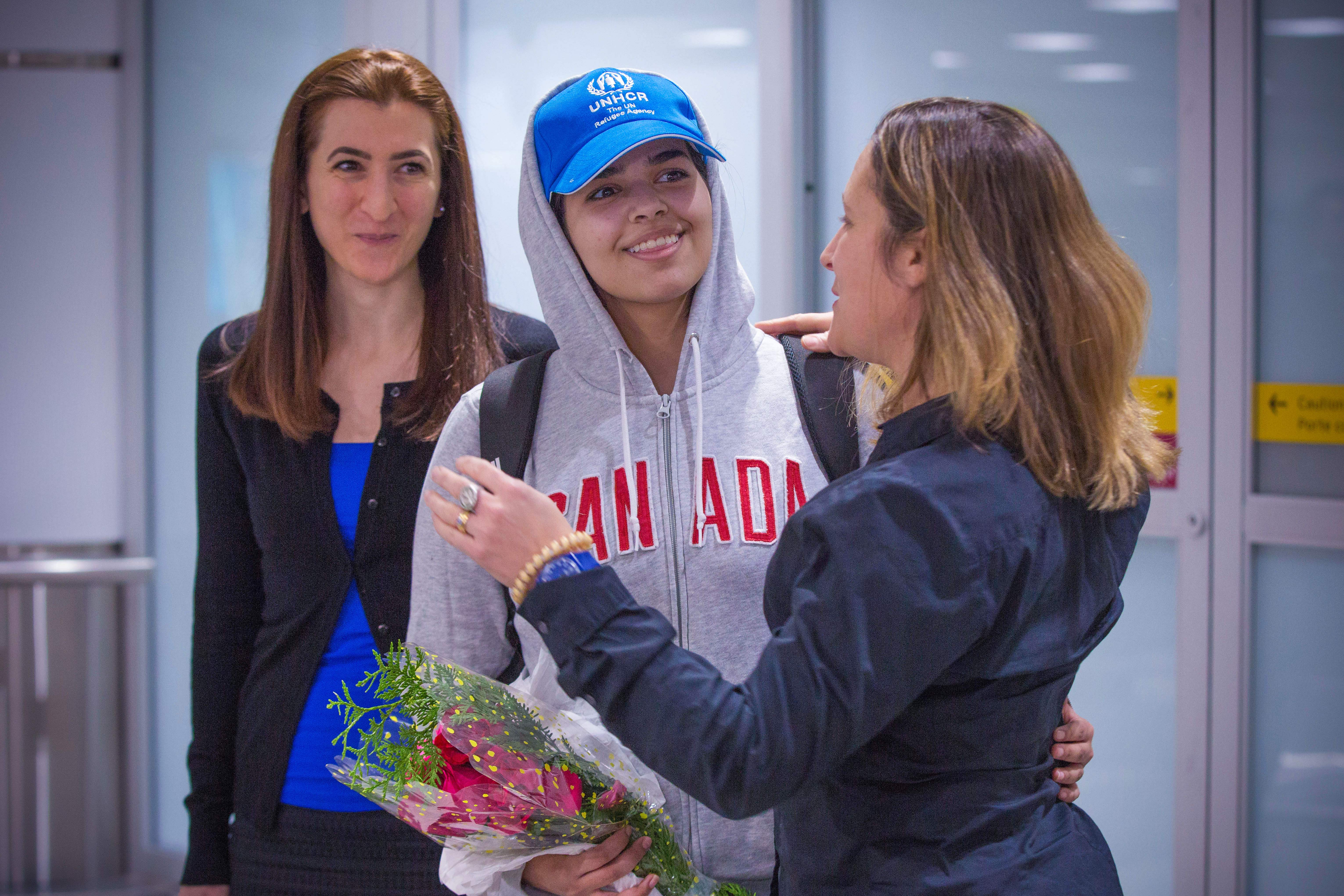 Saudi teenager Rahaf Mohammed al-Qunun is welcomed by Canadian Minister for Foreign Affairs Chrystia Freeland as she arrives at Pearson International airport in Toronto, Ontario, on January 12, 2019. The woman on the left is Saba Abbas from COSTI immigrant services. (Photo credit: LARS HAGBERG/AFP/Getty Images)