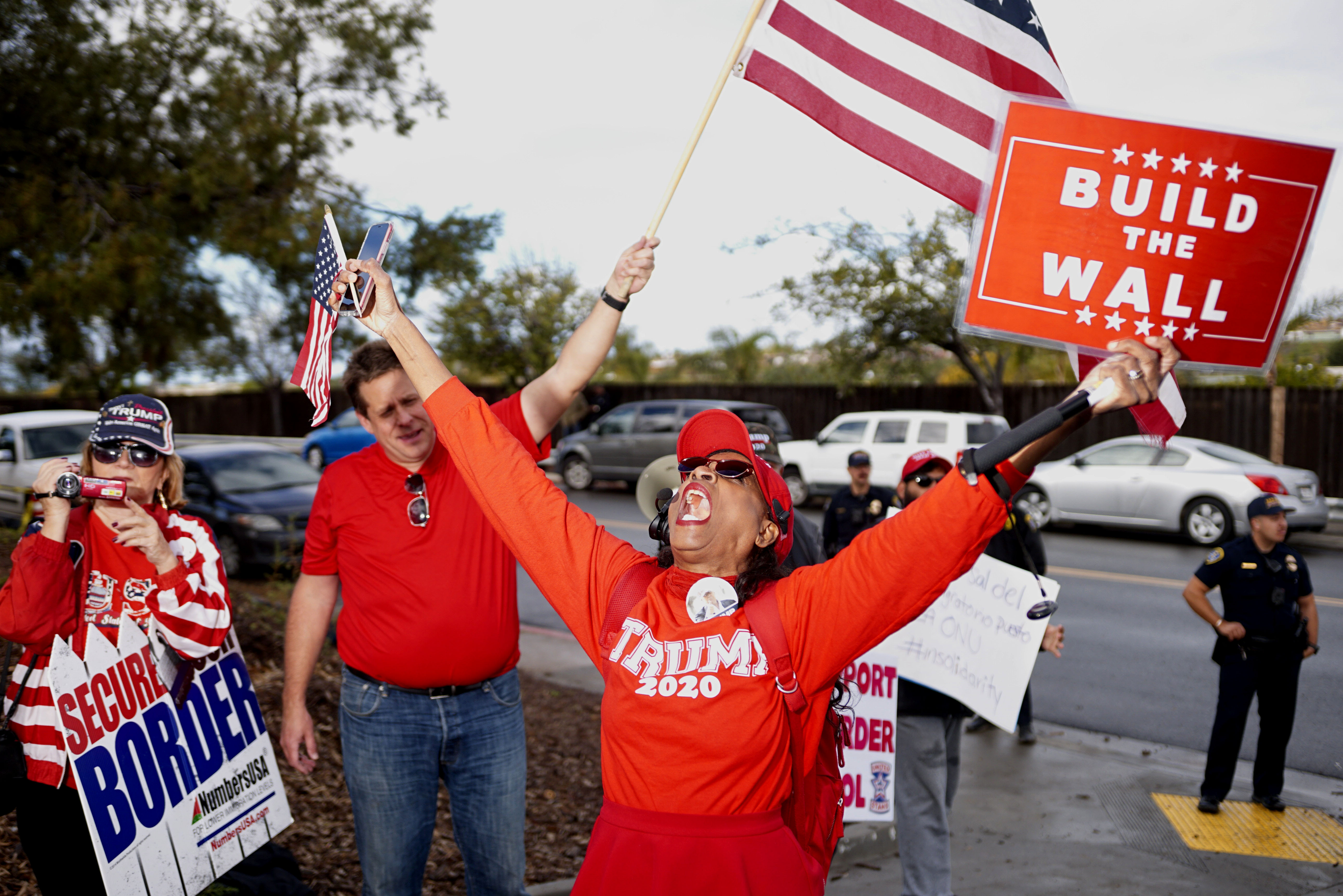 SAN YSIDRO, CA - Pro-wall demonstrators show signs of support for President Donald Trump and a border wall in front of a Border Patrol station on January 12, 2019 in San Ysidro, California. Credit: Sandy Huffaker/Getty Images