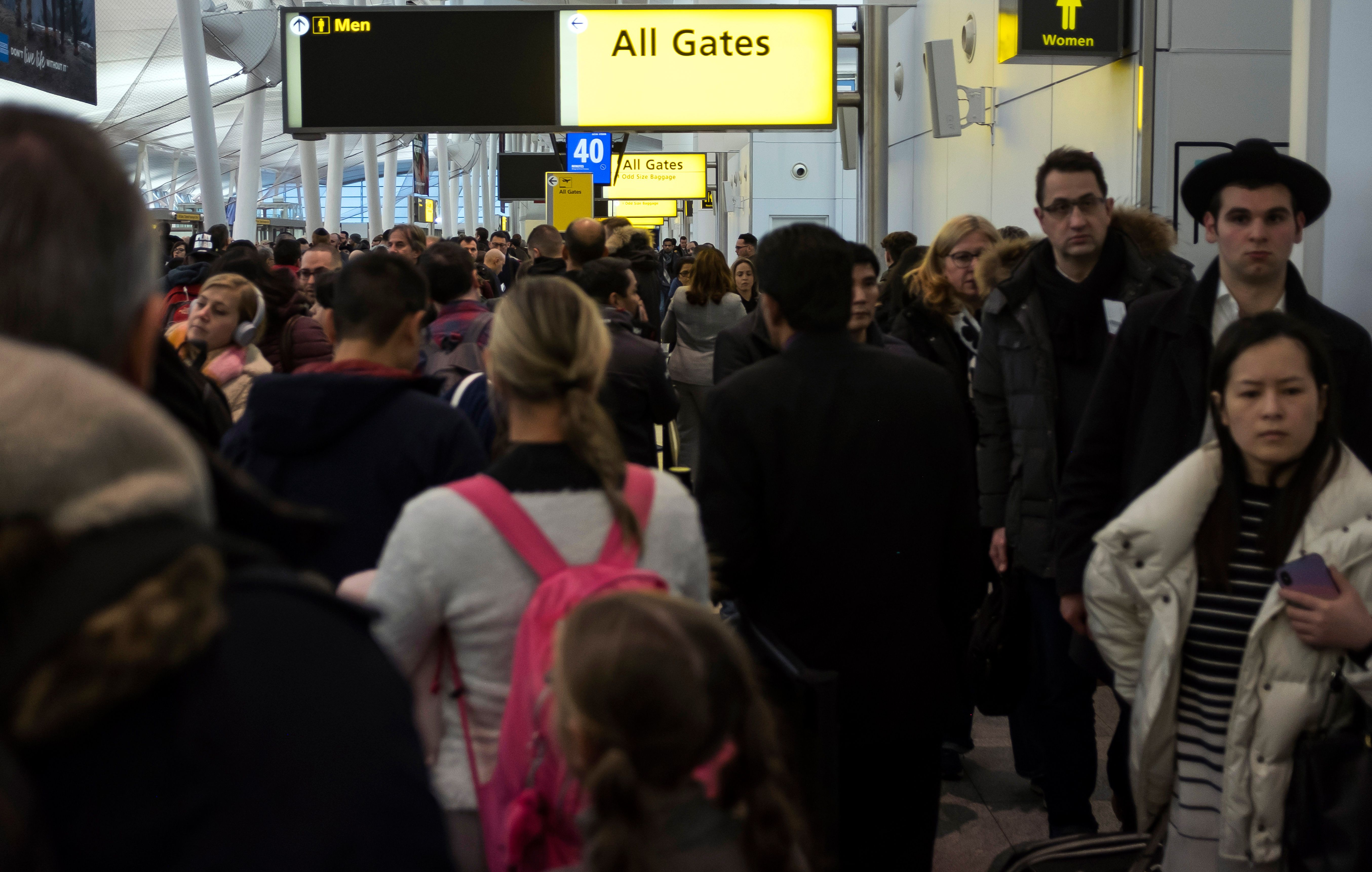 Passengers wait in a Transportation Security Administration (TSA) line at JFK airport on January 17, 2019 in New York City. - The longest government shutdown in US history continues and impacts travelling through airport. (Photo by Johannes EISELE / AFP) (Photo credit should read JOHANNES EISELE/AFP/Getty Images)