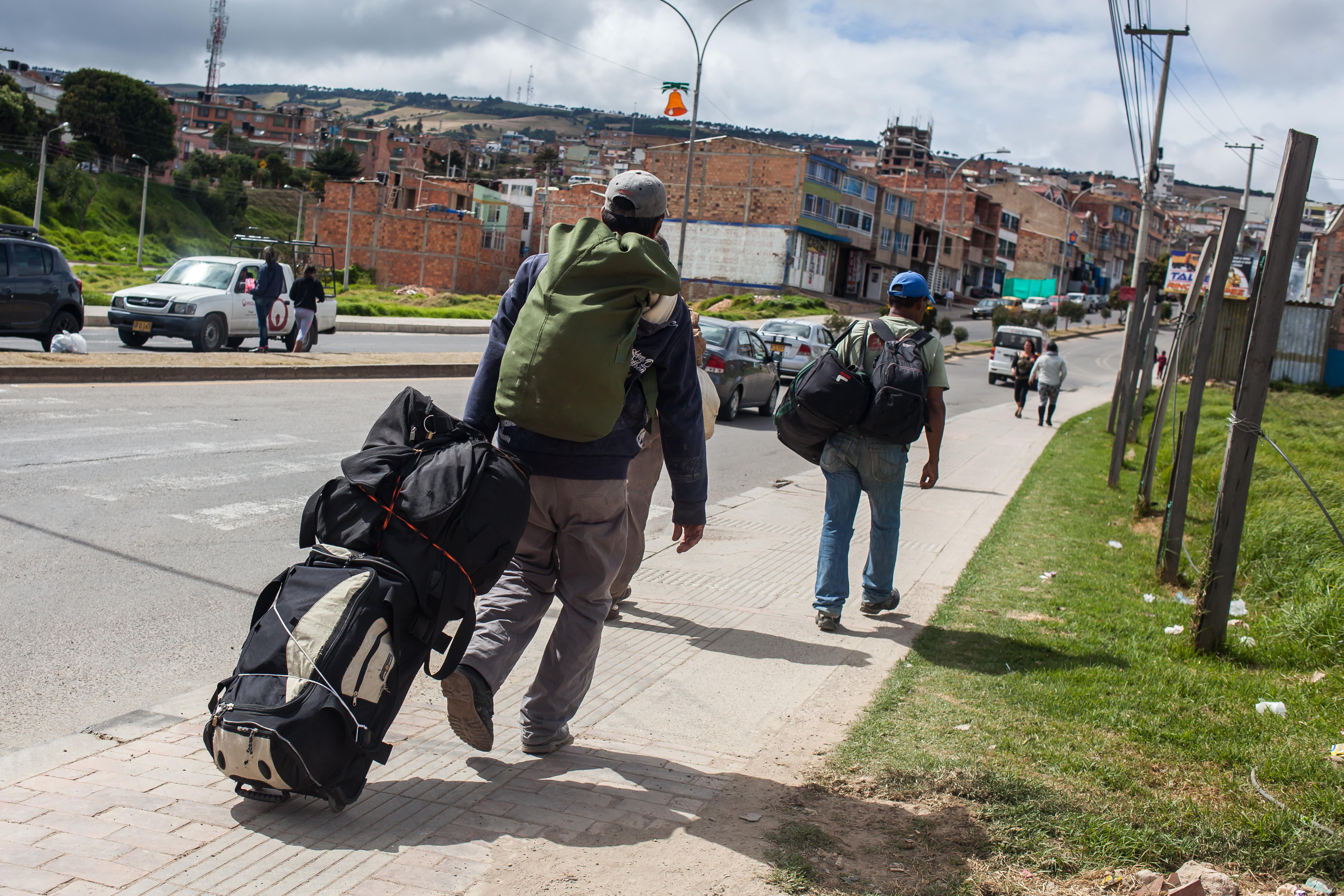 A group of Venezuelan migrants carry their belongings after leaving a temporary shelter on December 18, 2018 in Tunja, Boyaca, Colombia. Some people in Colombia have created shelters where Venezuelan migrants can sleep, eat and take a bath. Everyday these shelters receive about 40 kids who might suffer hypothermia, respiratory conditions or dehydration due to their challenging journey. (Credit: Juancho Torres/Getty Images)