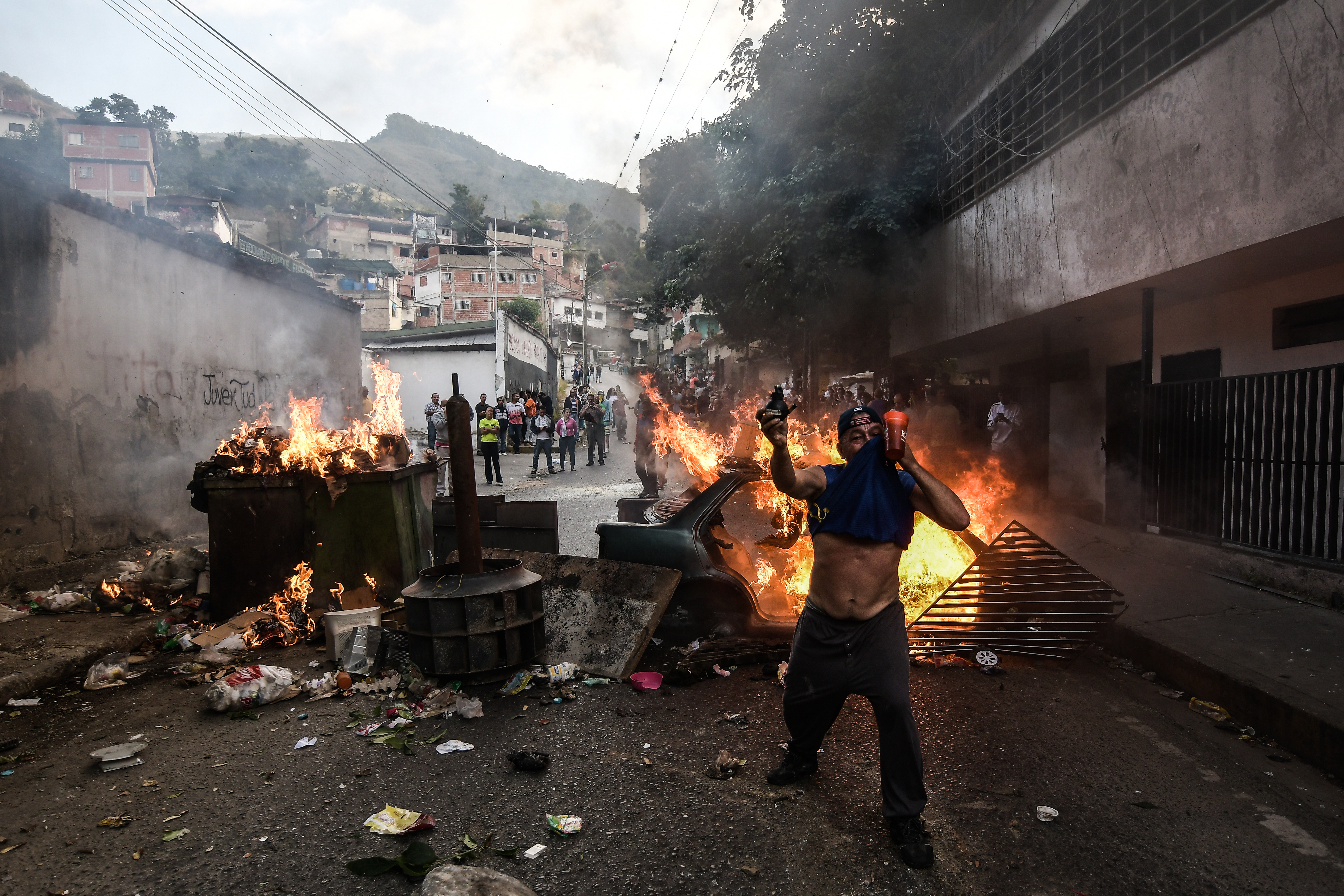 A protester is seen in front of a burning barricade during a protest against Nicolas Maduro.
27 Military officers of the National Guard were arrested after revolting in the command of Cotiza this January 21 in the city of Caracas.
CREDIT: Roman Camacho/SOPA Images/LightRocket via Getty Images.