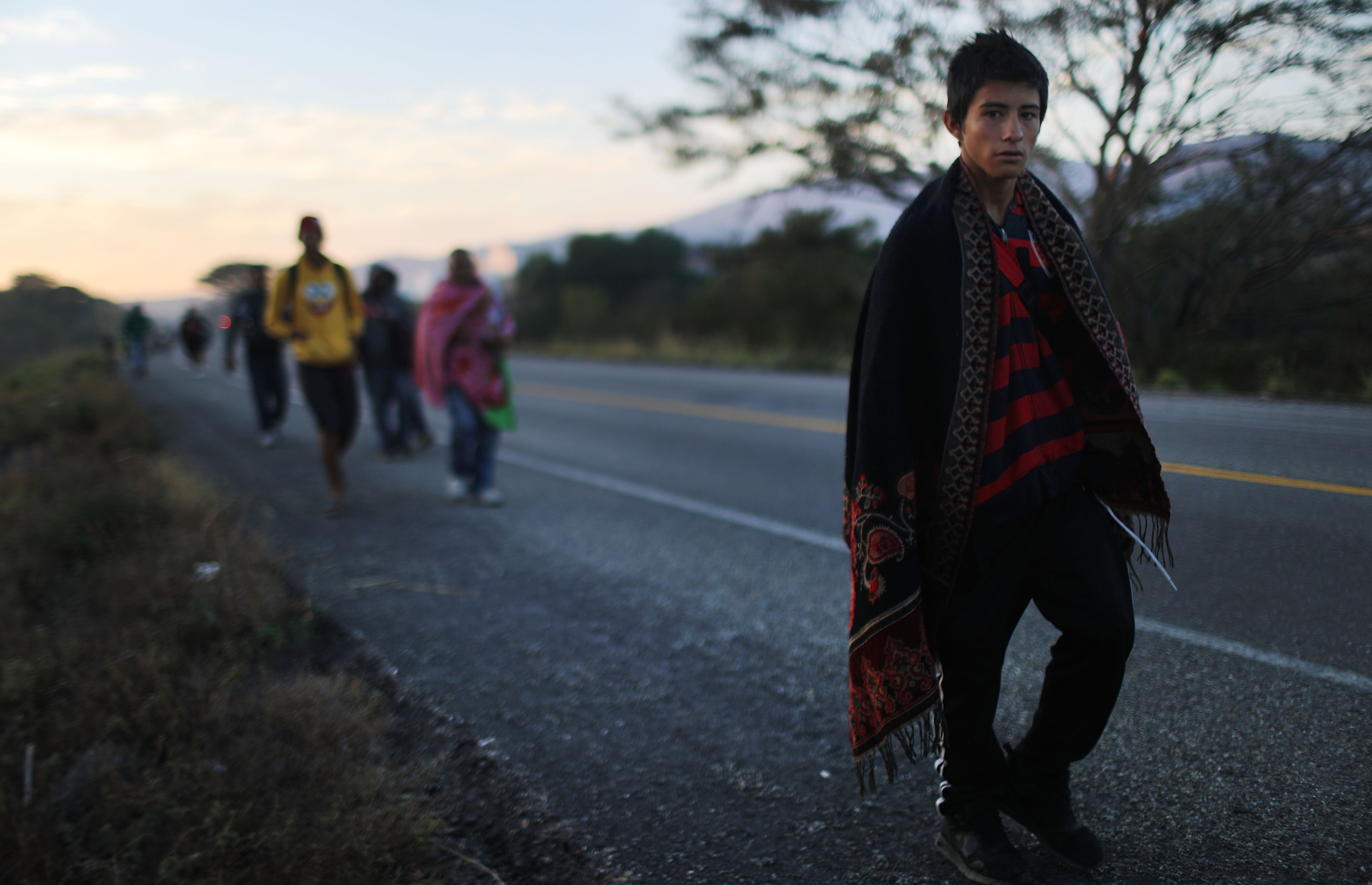 People from a caravan of Central American migrants walk alongside a highway, on their way toward the United States, on January 22, 2019 near Santo Domingo Zanatepec, Mexico. CREDIT: Mario Tama/Getty Images.