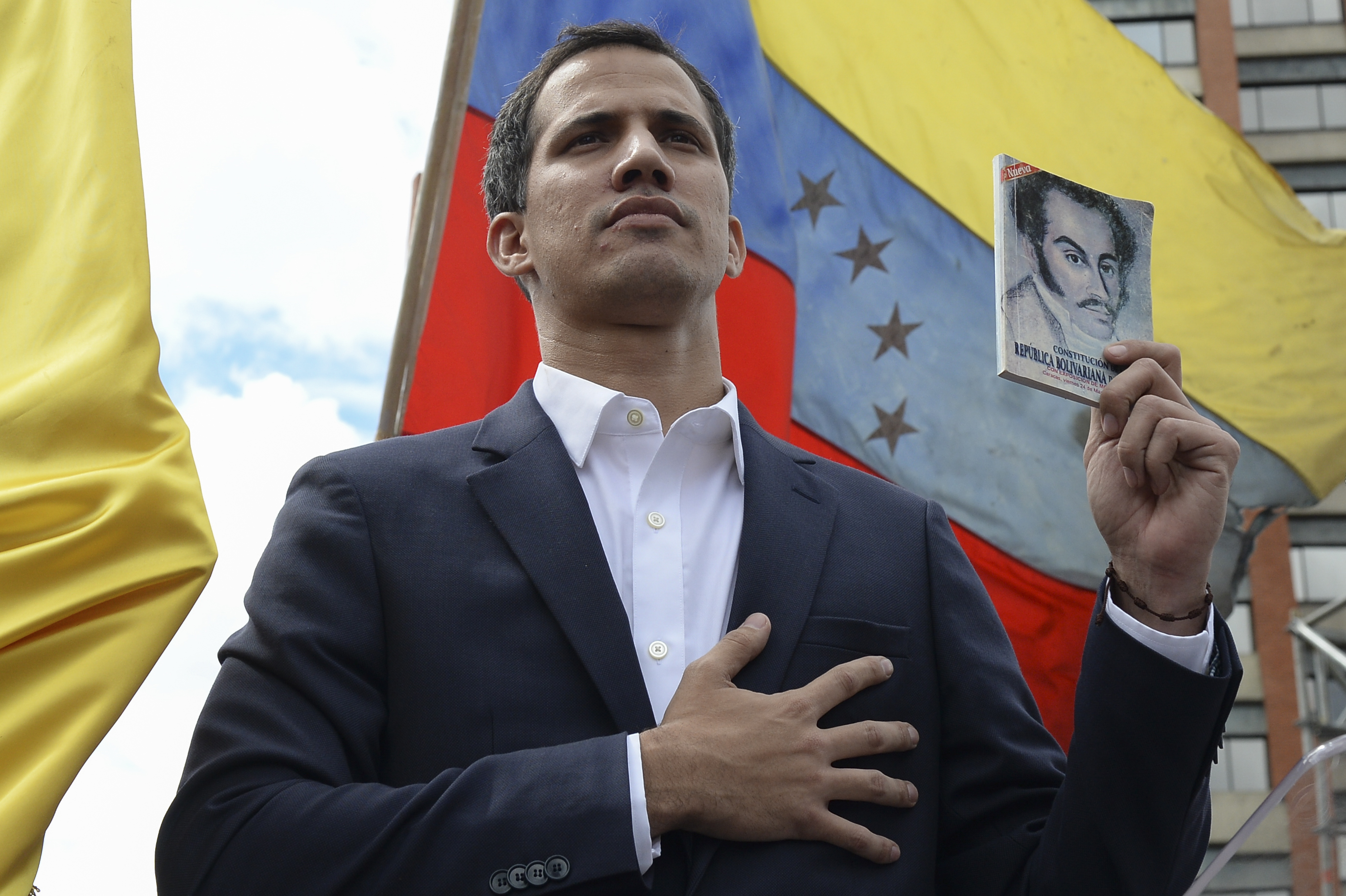 Venezuela's National Assembly head Juan Guaido declares himself the country's "acting president" during a mass opposition rally against leader Nicolas Maduro, on the anniversary of a 1958 uprising that overthrew military dictatorship in Caracas on January 23, 2019. - Moments earlier, the loyalist-dominated Supreme Court ordered a criminal investigation of the opposition-controlled legislature. CREDIT: Federico Parra/AFP/Getty Images.