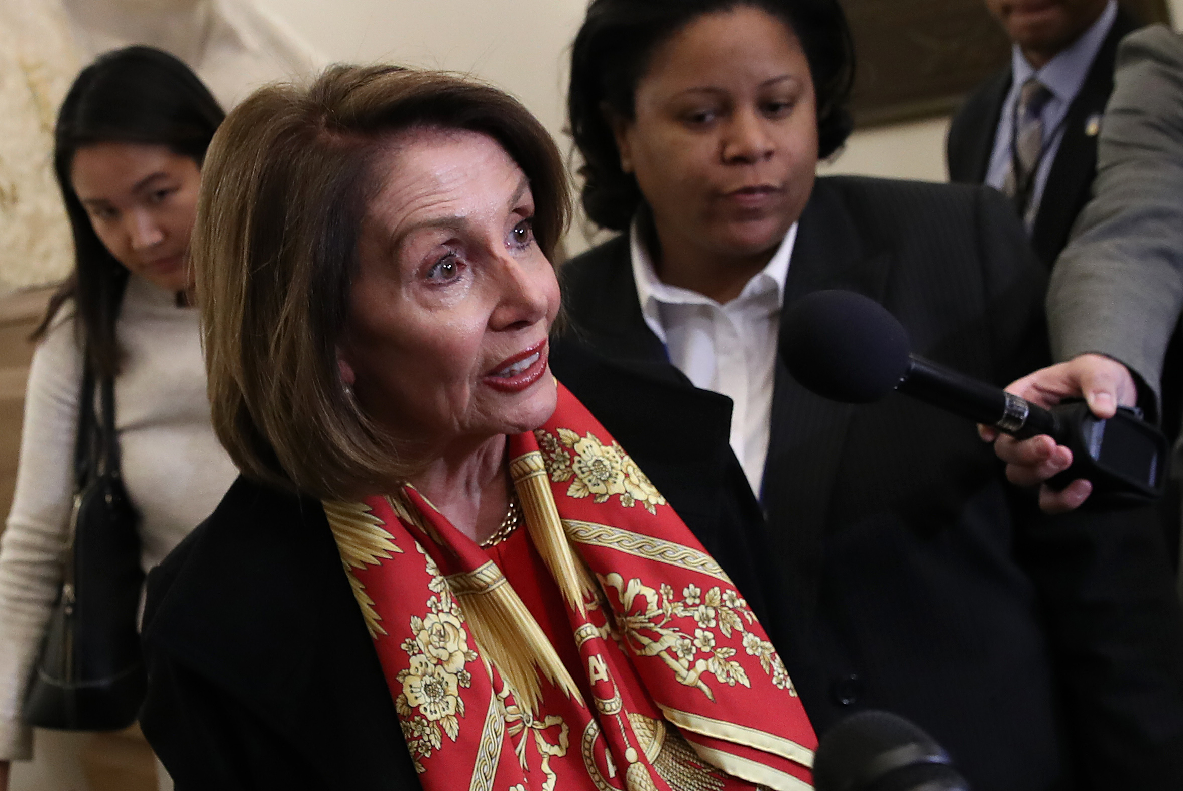 WASHINGTON, DC - JANUARY 23: U.S. Speaker of the House Nancy Pelosi (D-CA) (L) speaks to members of the press about U.S. President Donald Trump and the State of the Union speech while she returns to the U.S. Capitol on January 23, 2019 in Washington, DC. (Photo by Win McNamee/Getty Images)