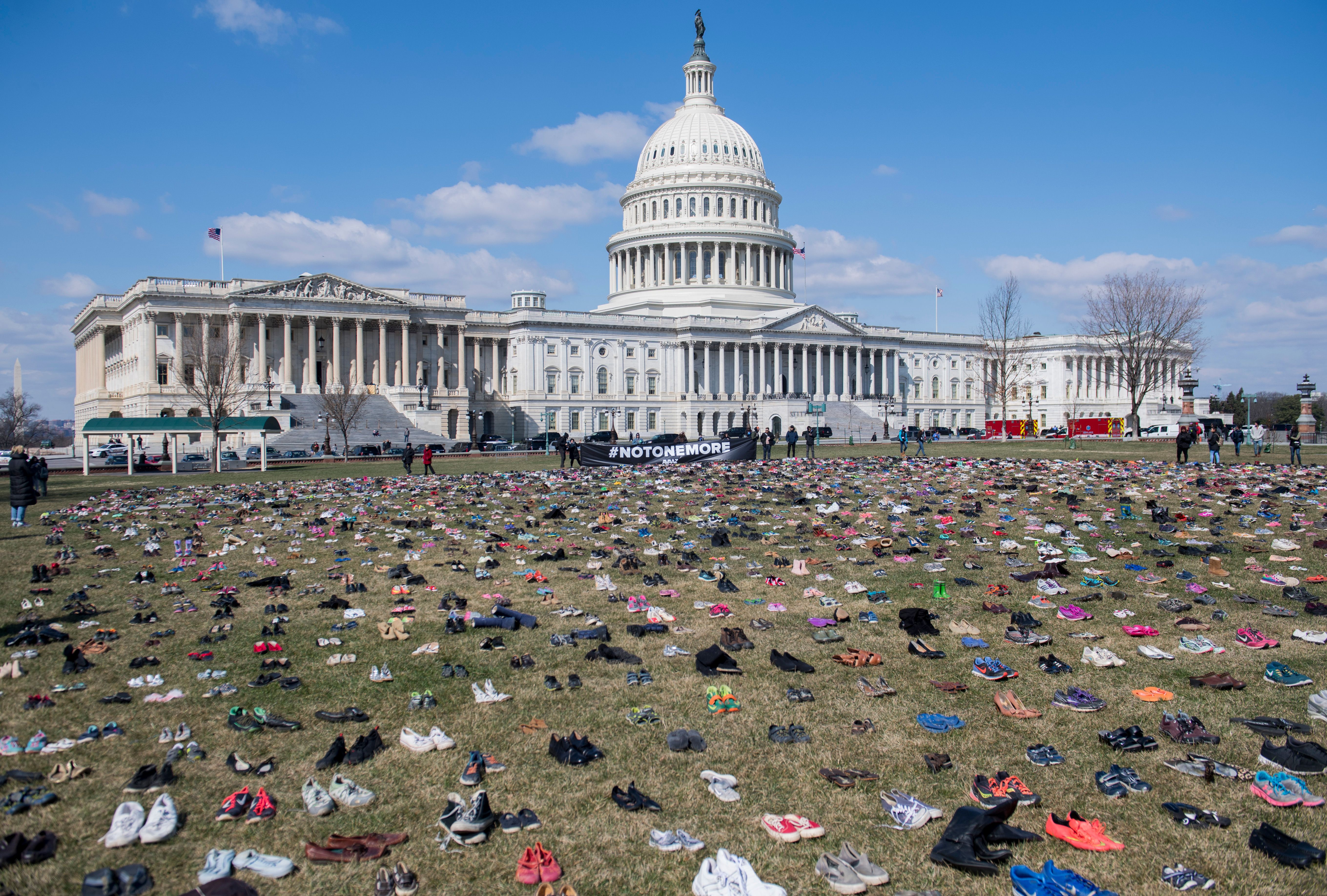 The lawn outside the US Capitol is covered with 7,000 pairs of empty shoes to memorialize the 7,000 children killed by gun violence since the Sandy Hook school shooting. (Photo credit should read SAUL LOEB/AFP/Getty Images)