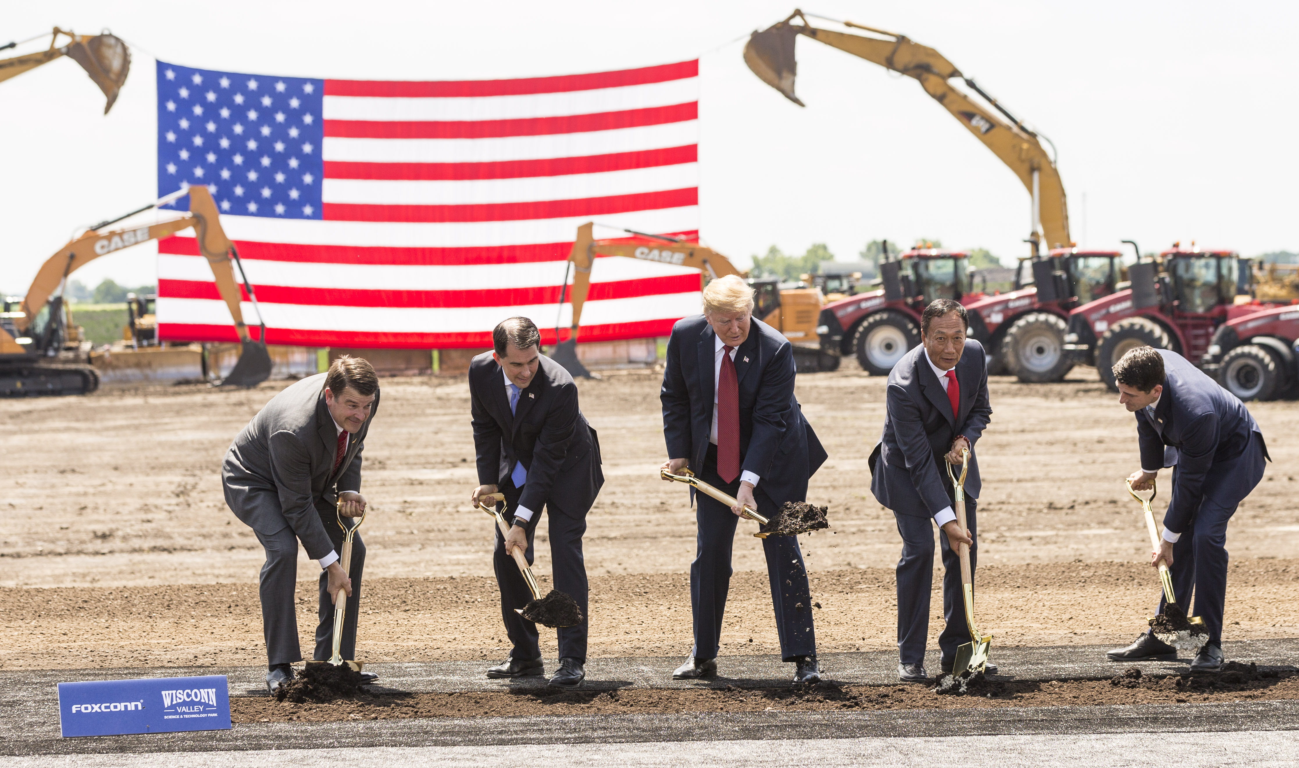 U.S. President Donald Trump (C) breaks ground with Wisconsin Gov. Scott Walker (2nd L), Foxconn CEO Terry Gou (2nd R), U.S. House Speaker Paul Ryan (R-WI) (R) and Christopher “Tank” Murdock (L), the first Wisconsin Foxconn employee, at a ceremony for the Foxconn Technology Group computer screen plant on June 28, 2018 in Mt Pleasant, Wisconsin. Foxconn has committed to build a $10 billion plant in what it has named the Wisconn Valley Science and Technology Park, and to creating 13,000 Wisconsin jobs. (Credit: Andy Manis/Getty Images)