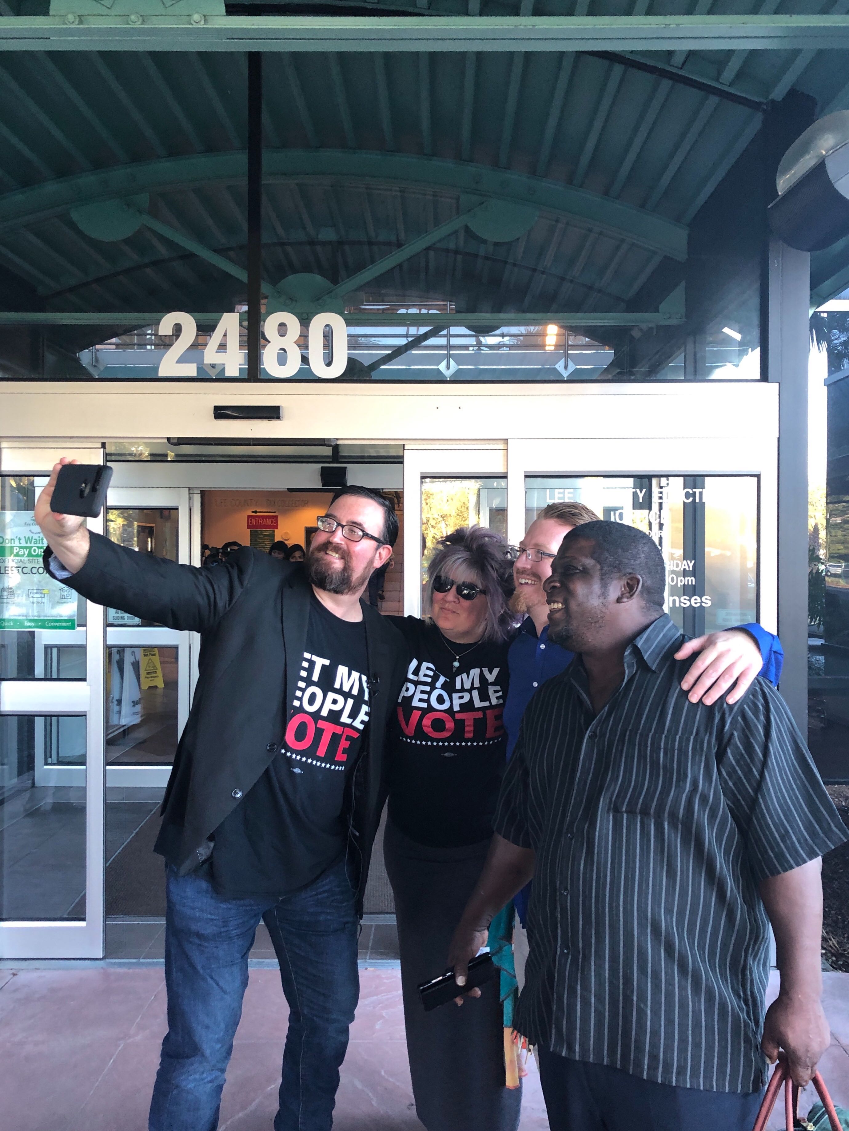Neil and Pam Volz, Lance Wissinger, and Perman Thomas take a selfie outside the county building. CREDIT: Addy Baird