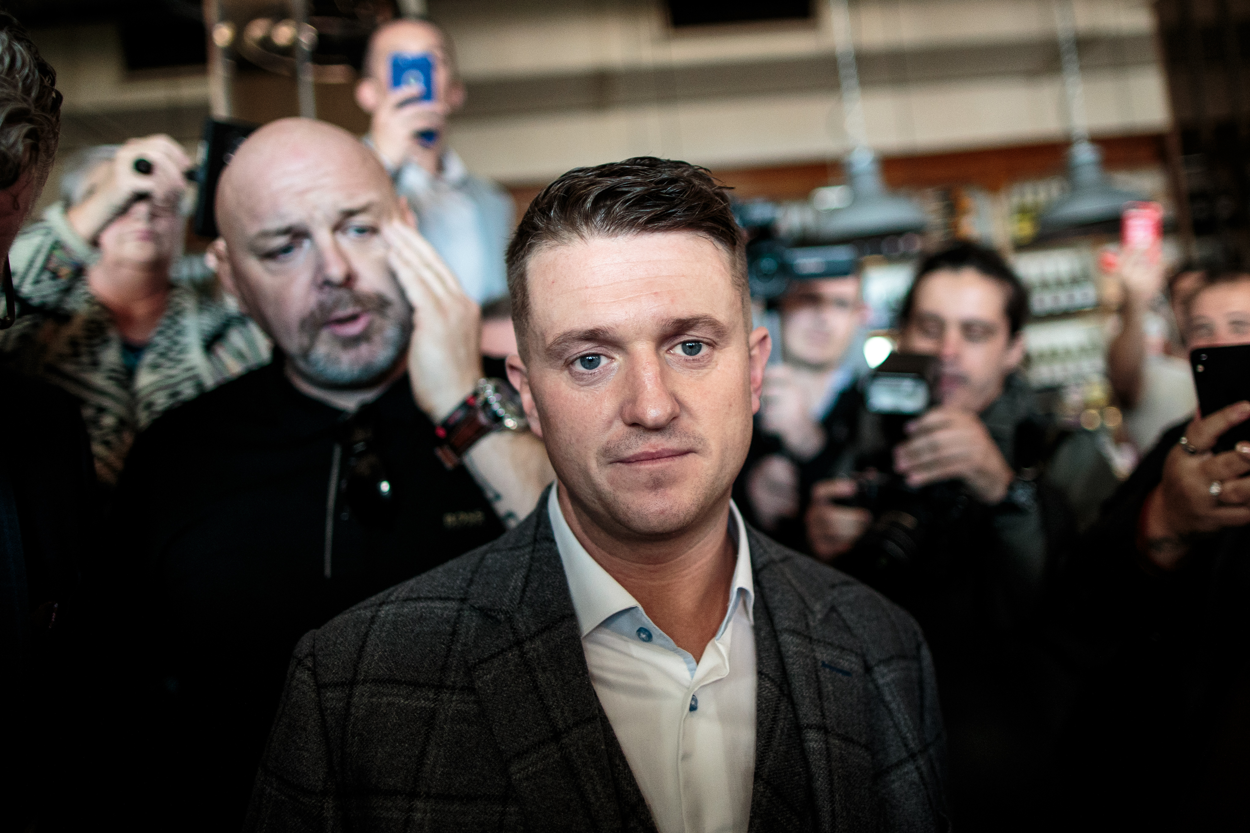 Far-right figurehead Tommy Robinson (C), real name Stephen Yaxley-Lennon, was banned from Facebook this week over incendiary and threatening posts encouraging his followers to target Muslims. (Photo credit: Jack Taylor/Getty Images)