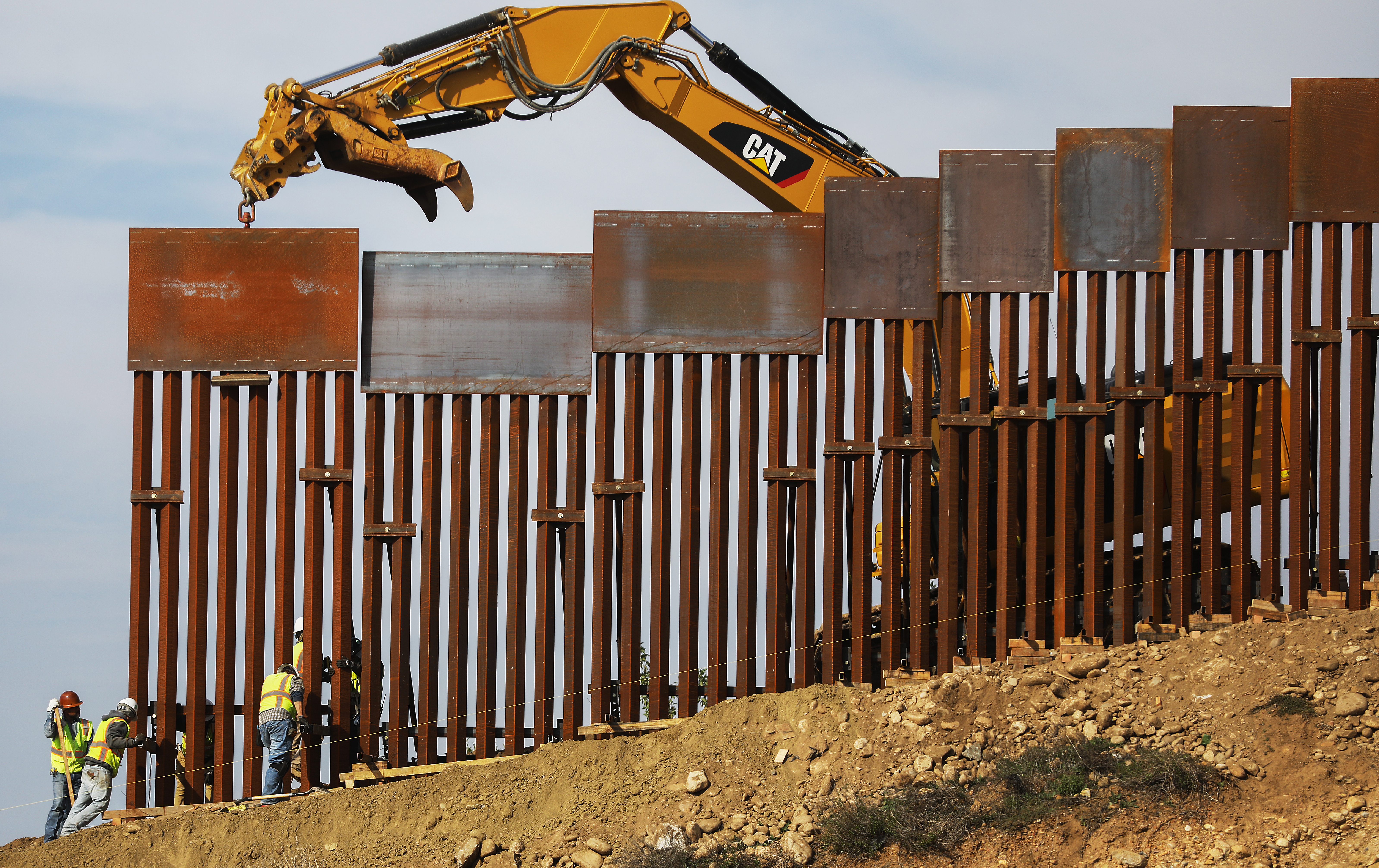 A construction crew installs new sections of the U.S.-Mexico border barrier replacing smaller fences on January 11, 2019 as seen from Tijuana, Mexico. (Photo by Mario Tama/Getty Images)